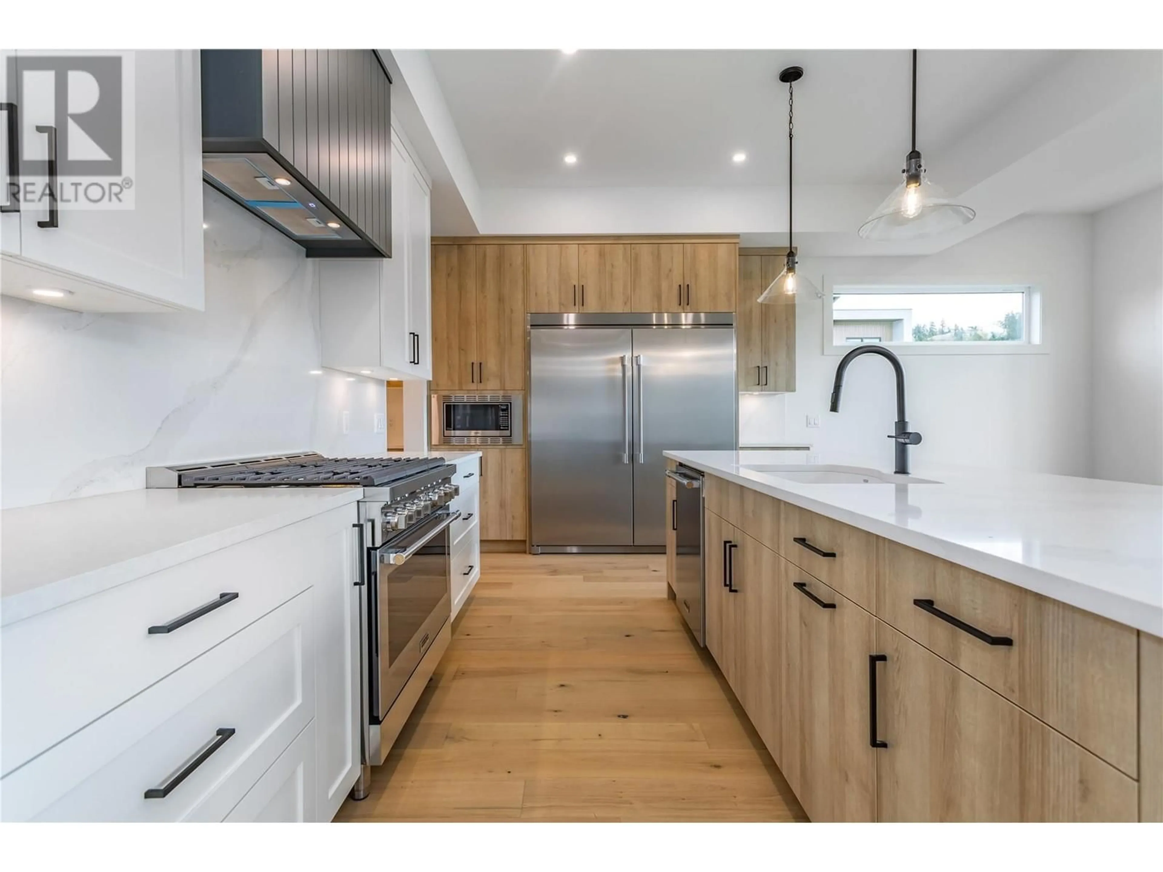 Open concept kitchen, wood/laminate floor for 907 Bull Crescent Lot# 91, Kelowna British Columbia V1W0B6