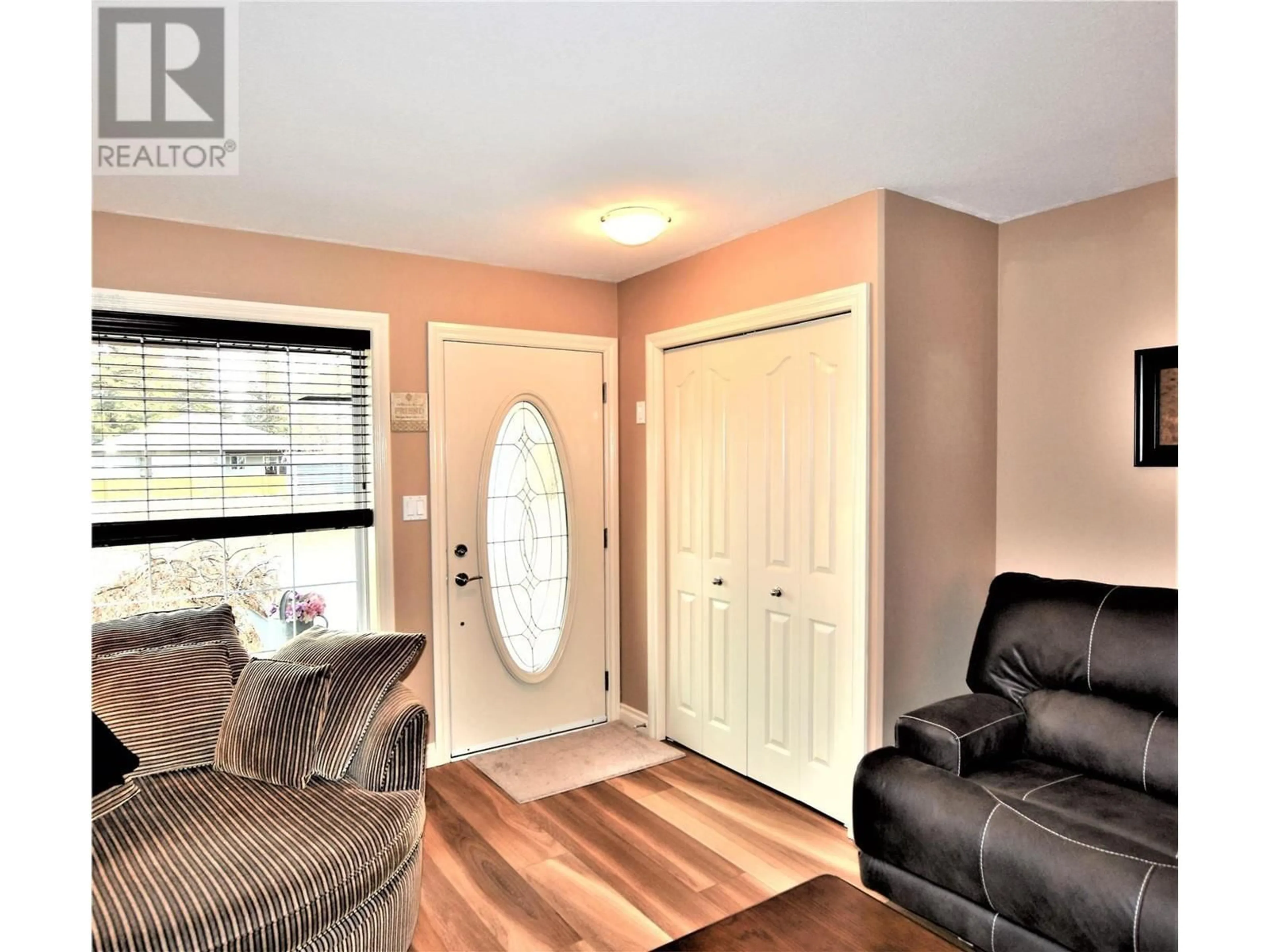 Living room with furniture, wood/laminate floor for 519 LOON AVENUE, Vernon British Columbia V1H2A1
