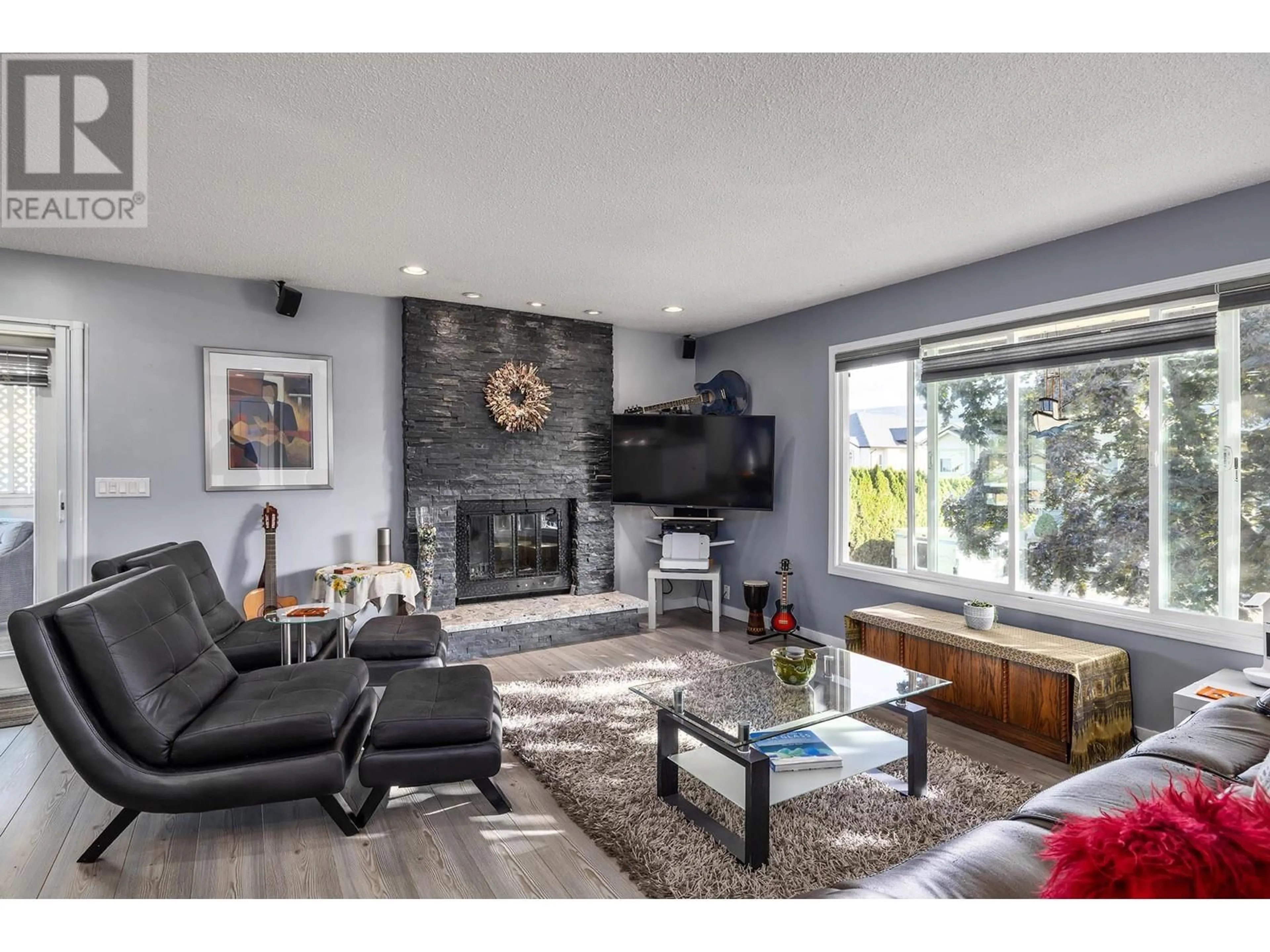 Living room with furniture, wood/laminate floor for 706 Renshaw Road, Kelowna British Columbia V1X6C8