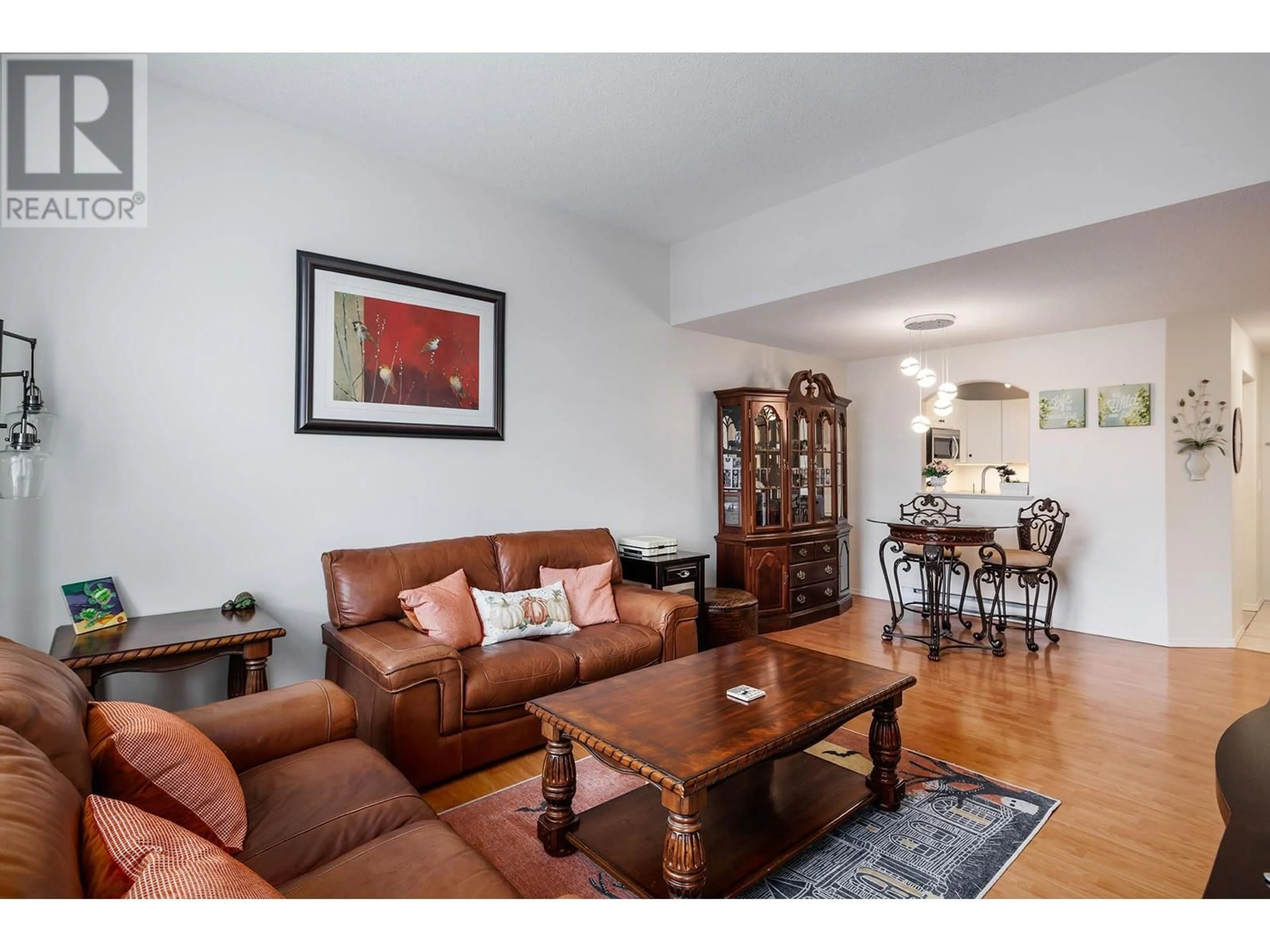 Living room with furniture, wood/laminate floor for 301 - 555 HOUGHTON ROAD, Kelowna British Columbia V1X7P9
