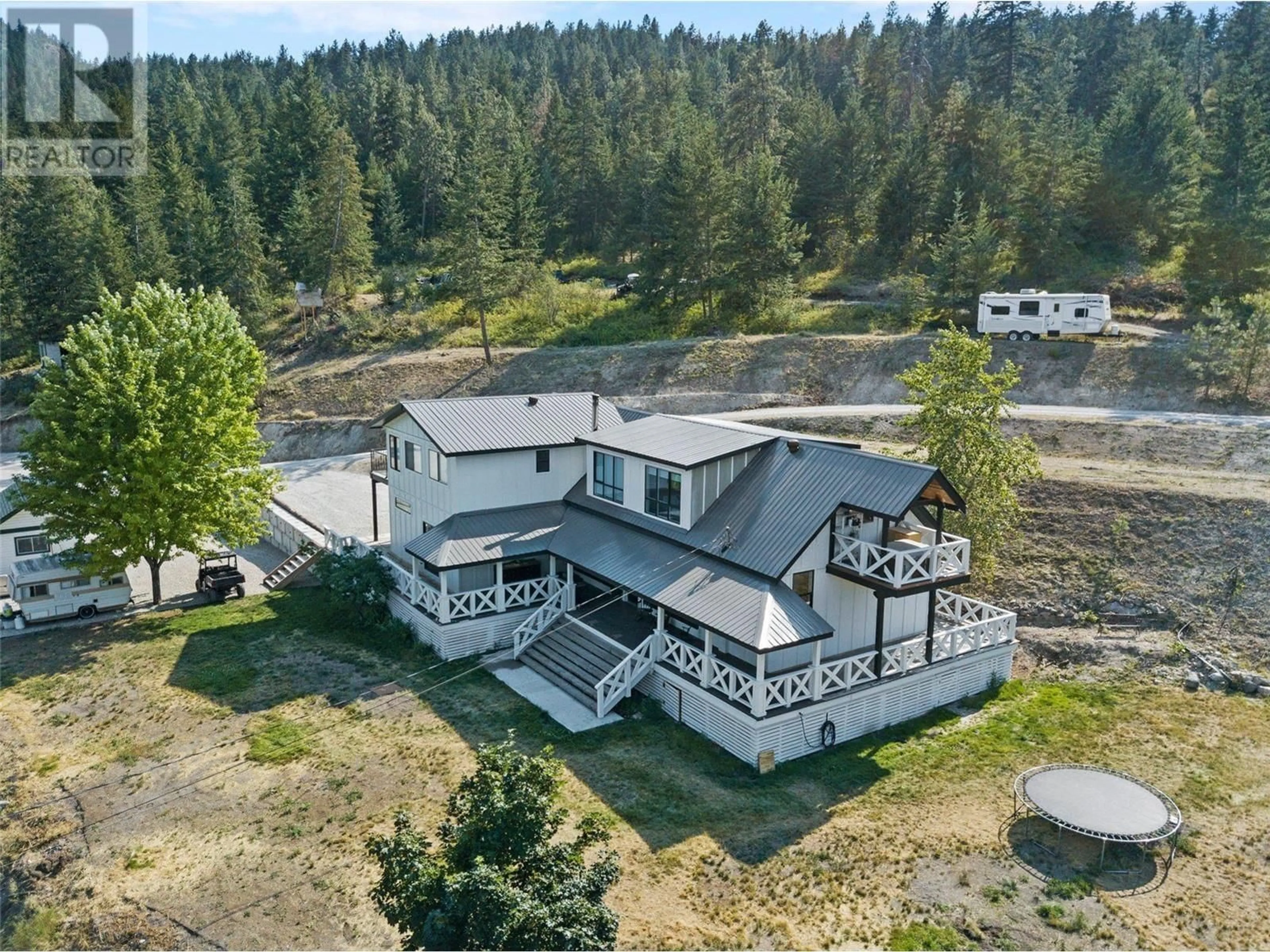 A pic from outside/outdoor area/front of a property/back of a property/a pic from drone, mountain view for 7810 Highway 97 N, Kelowna British Columbia V4V1T3