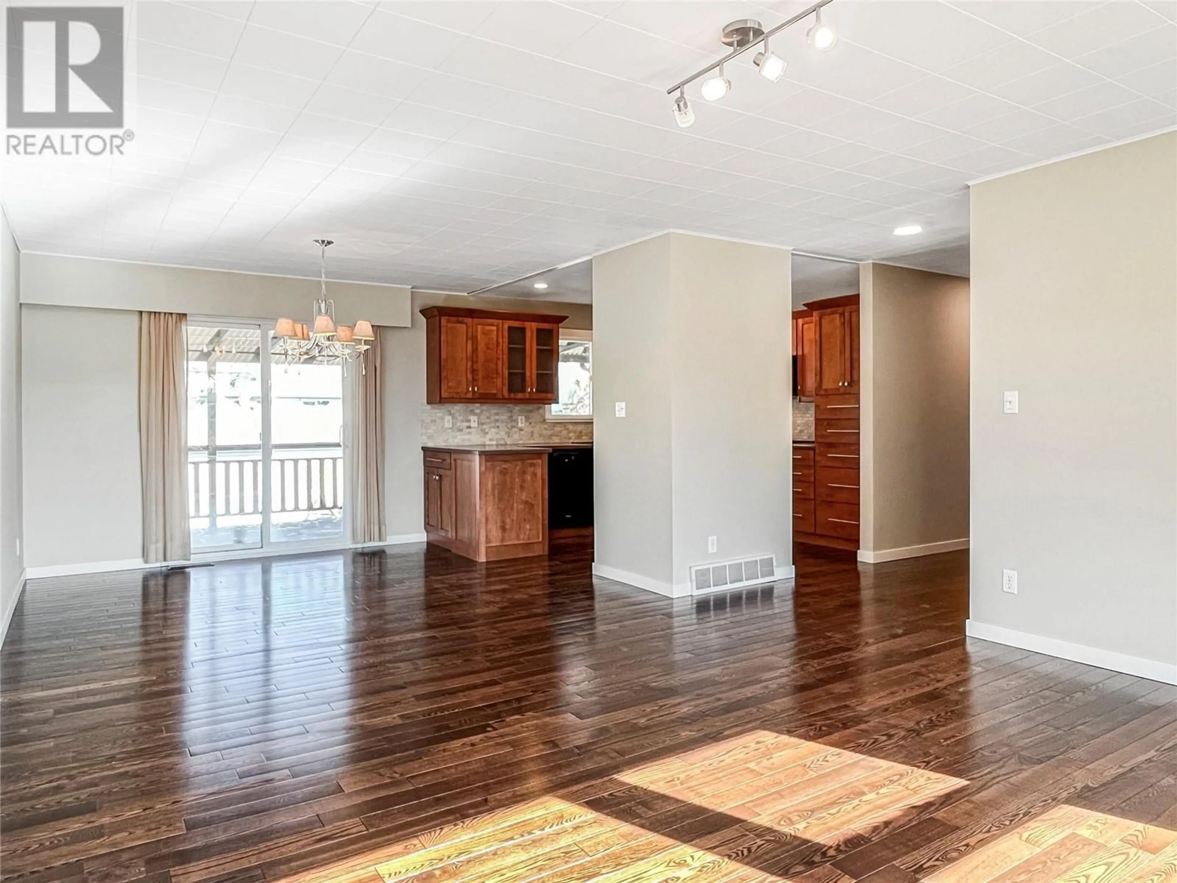 Open concept kitchen, wood/laminate floor for 38 WILLOW CRESCENT, Osoyoos British Columbia V0H1V3