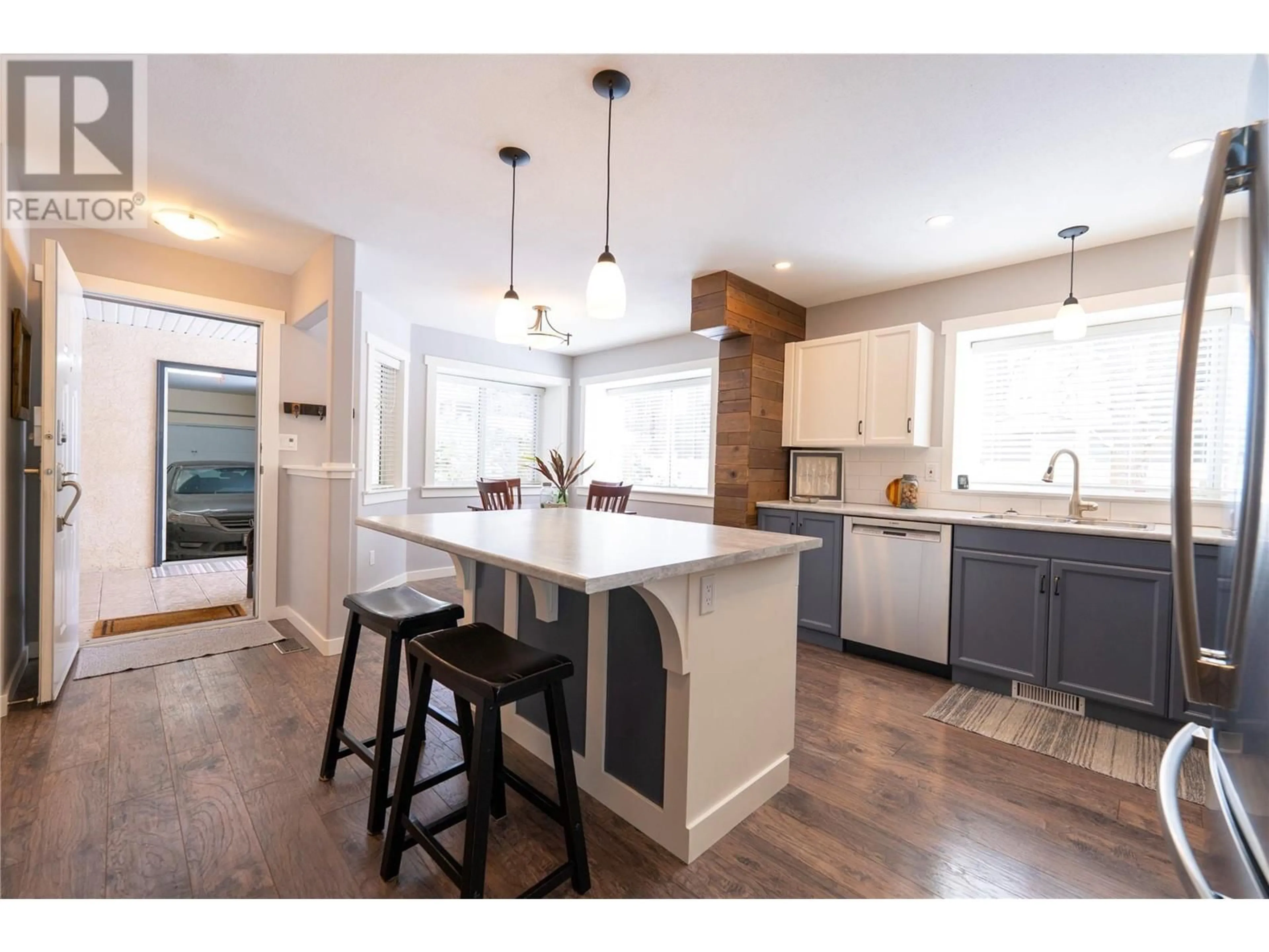 Open concept kitchen, wood/laminate floor for 313 Whitman Road Unit# 1, Kelowna British Columbia V1V2J4