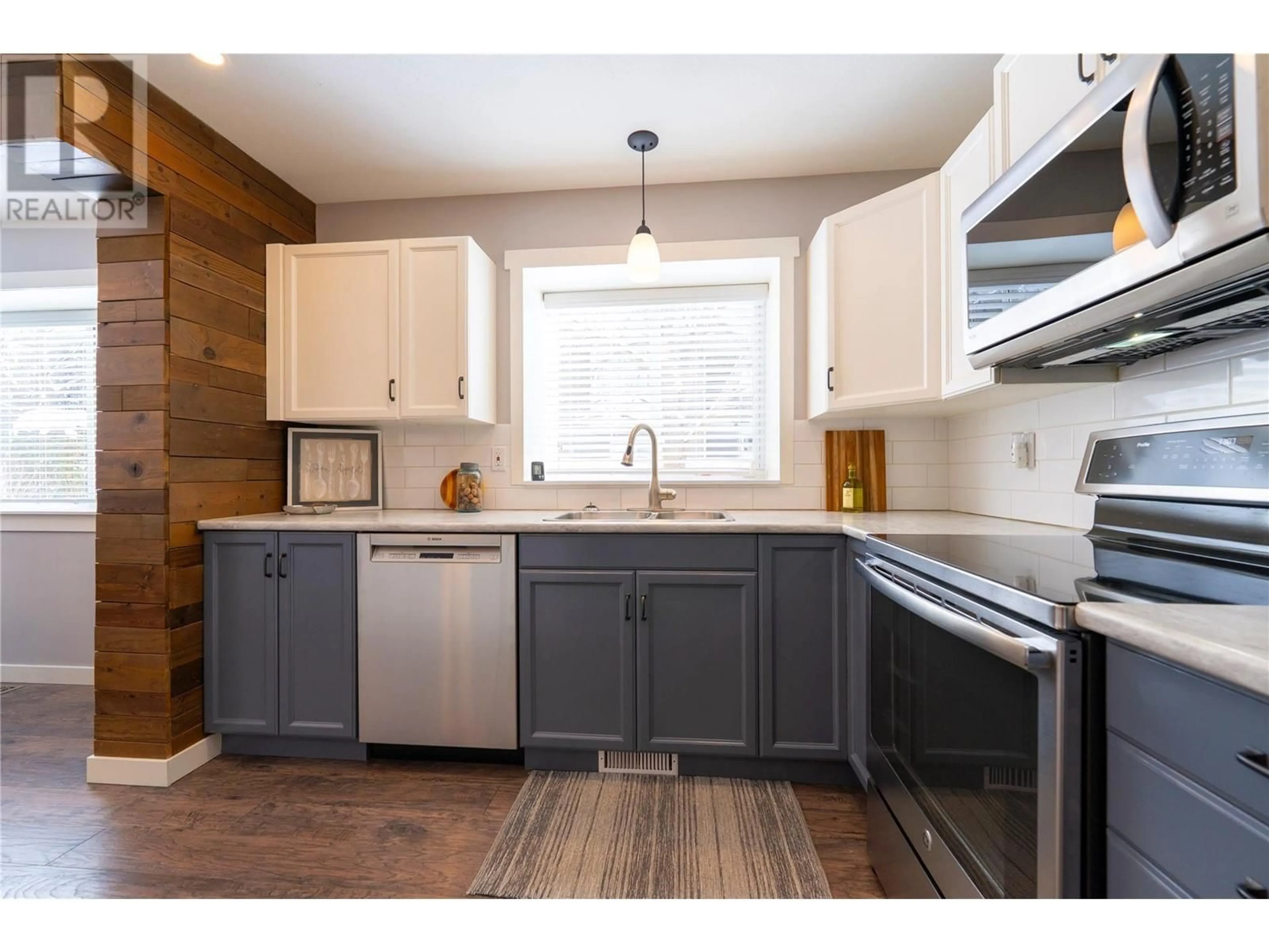 Open concept kitchen, wood/laminate floor for 313 Whitman Road Unit# 1, Kelowna British Columbia V1V2J4