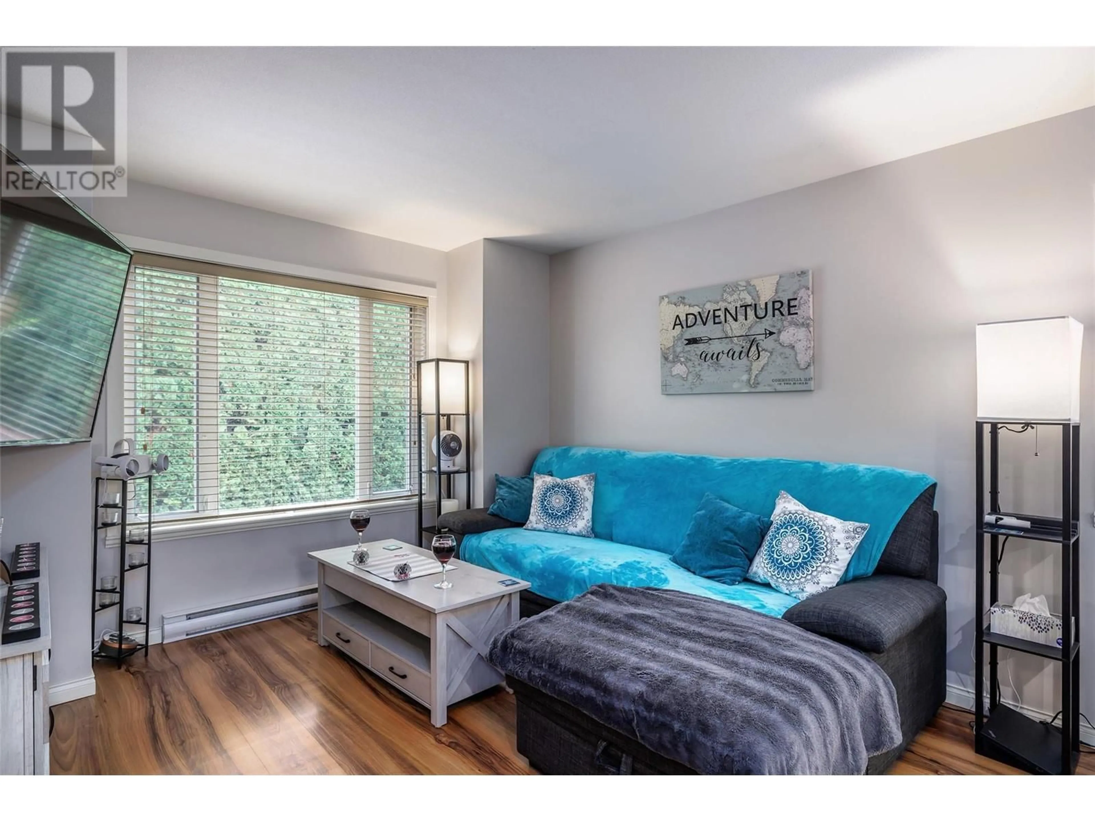 Living room with furniture, wood/laminate floor for 1945 Bowes Street, Kelowna British Columbia V1Y3C2