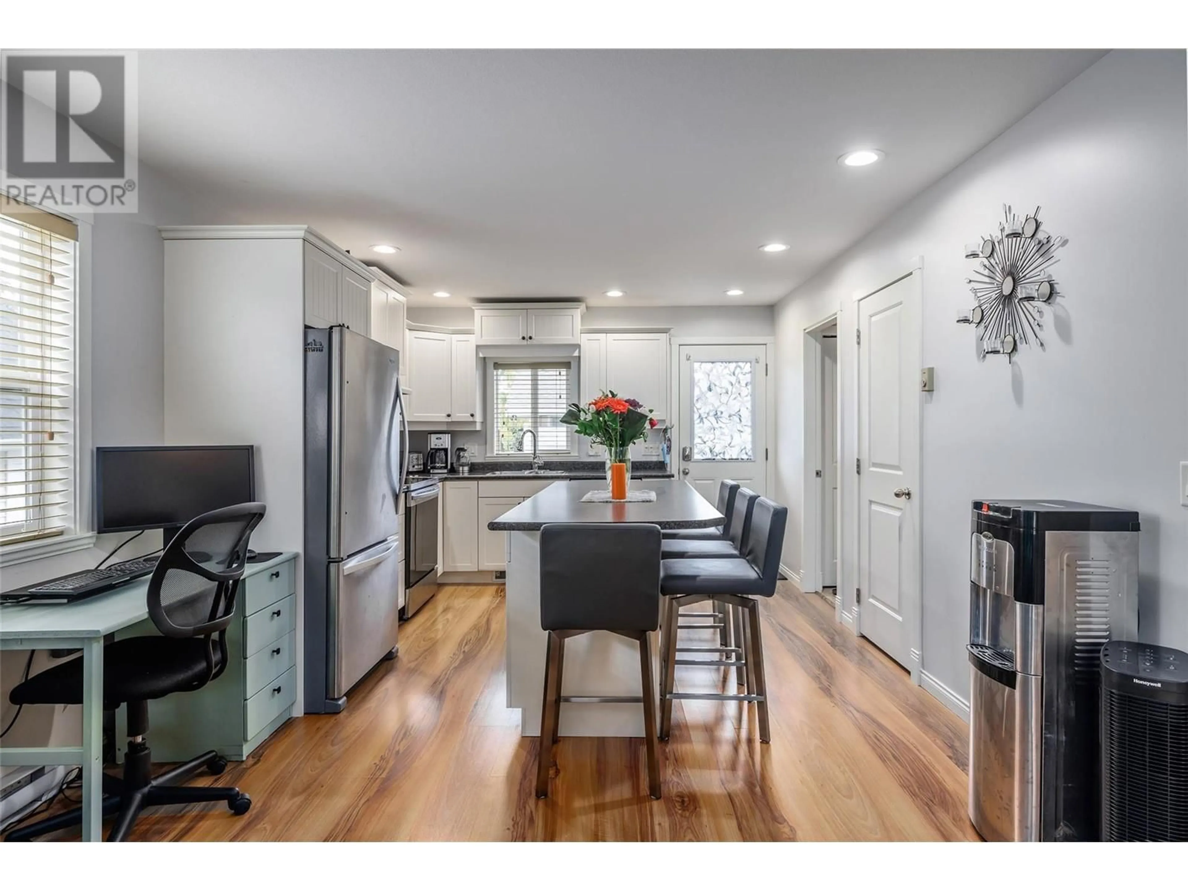 Open concept kitchen, wood/laminate floor for 1945 Bowes Street, Kelowna British Columbia V1Y3C2