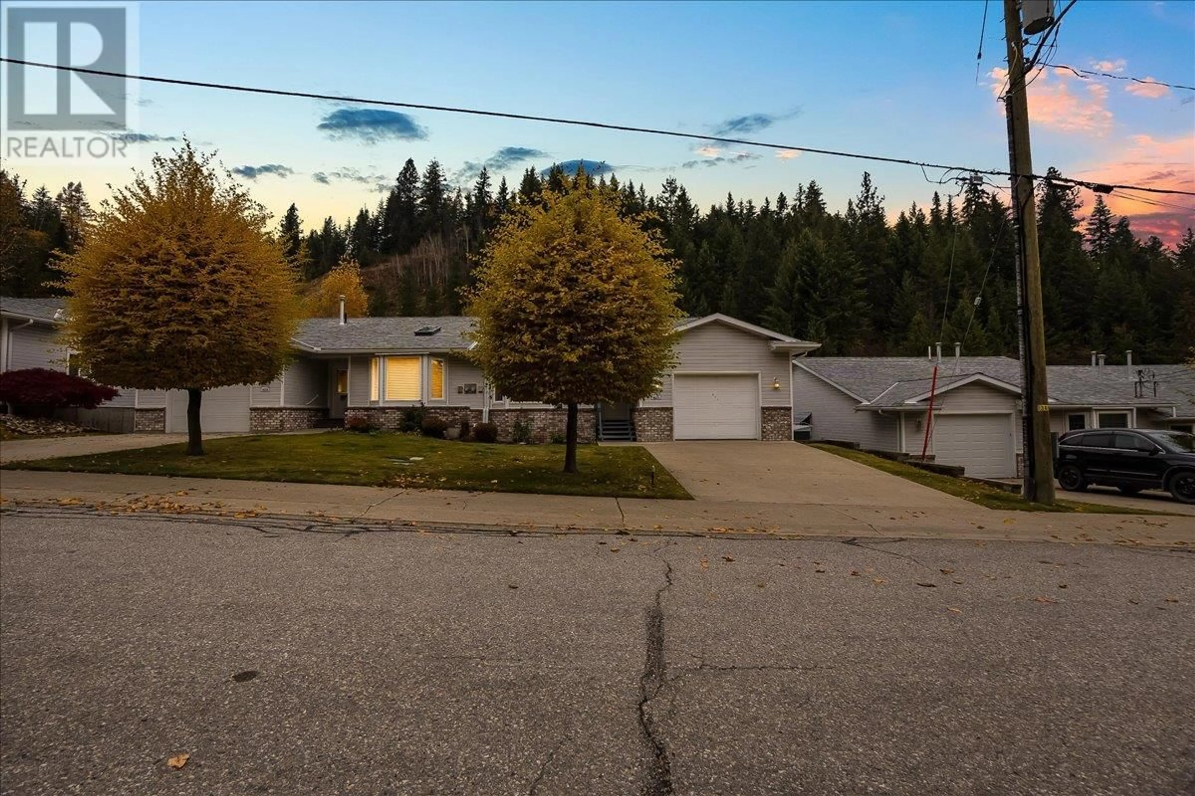 A pic from outside/outdoor area/front of a property/back of a property/a pic from drone, street for 825 Merrycreek Road Unit# 111, Castlegar British Columbia V1N2P1