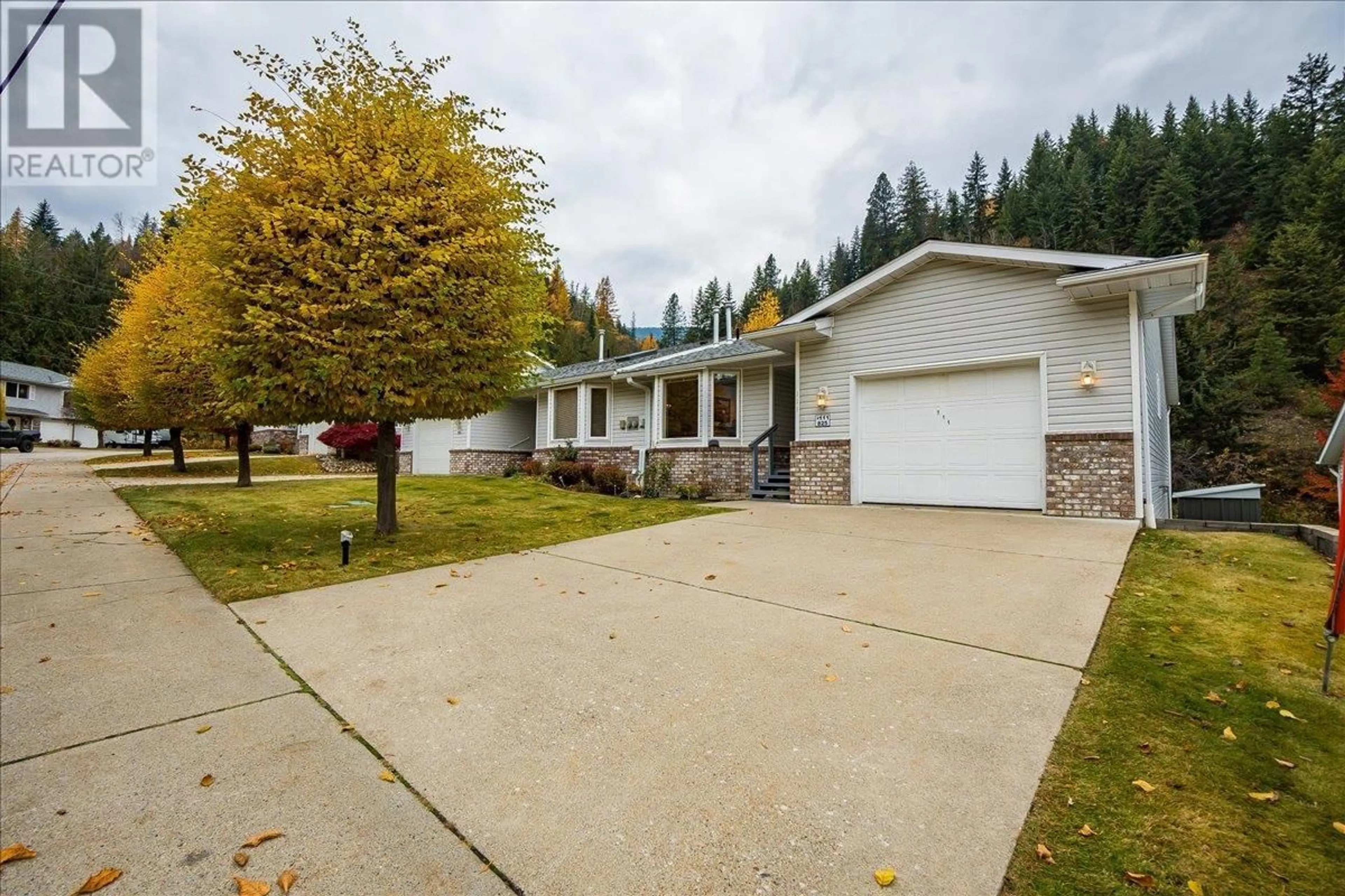 A pic from outside/outdoor area/front of a property/back of a property/a pic from drone, street for 825 Merrycreek Road Unit# 111, Castlegar British Columbia V1N2P1