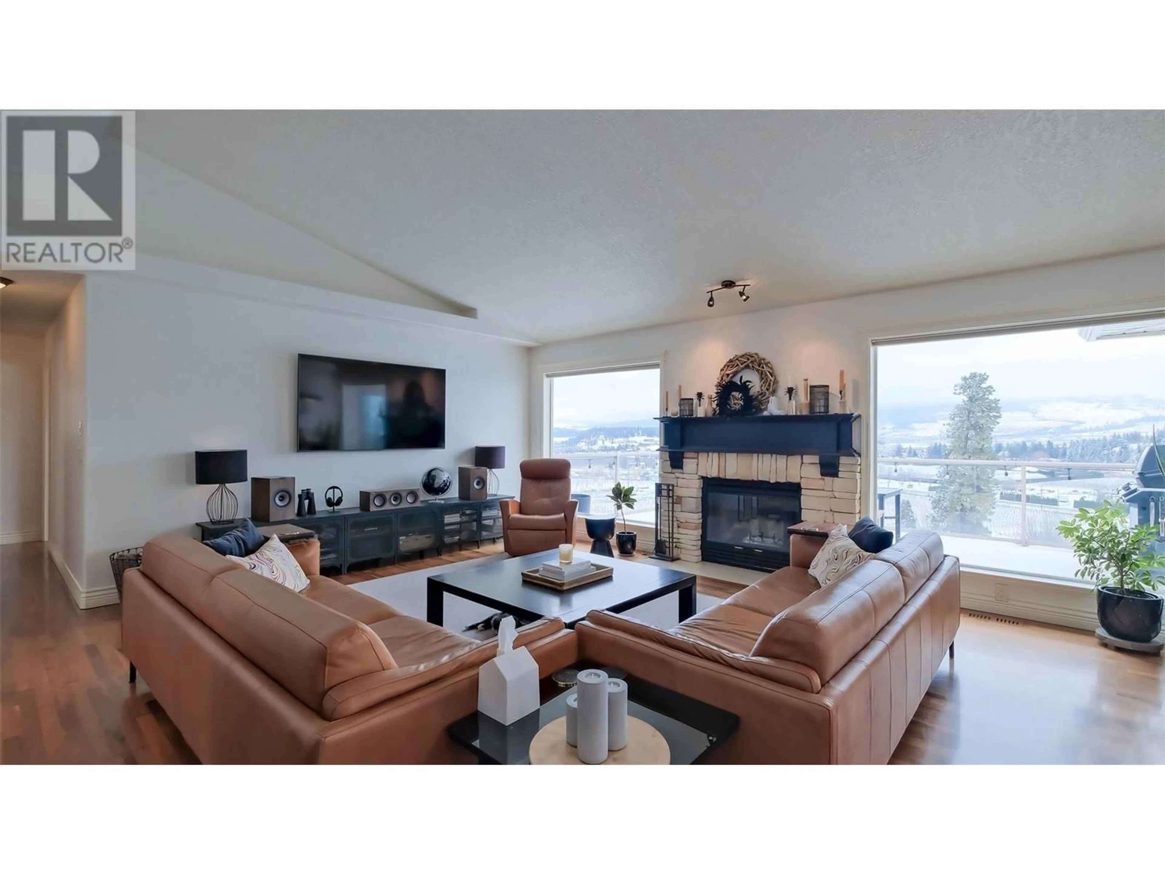 Living room with furniture, wood/laminate floor for 2377 Silver Place, Kelowna British Columbia V1V1M9