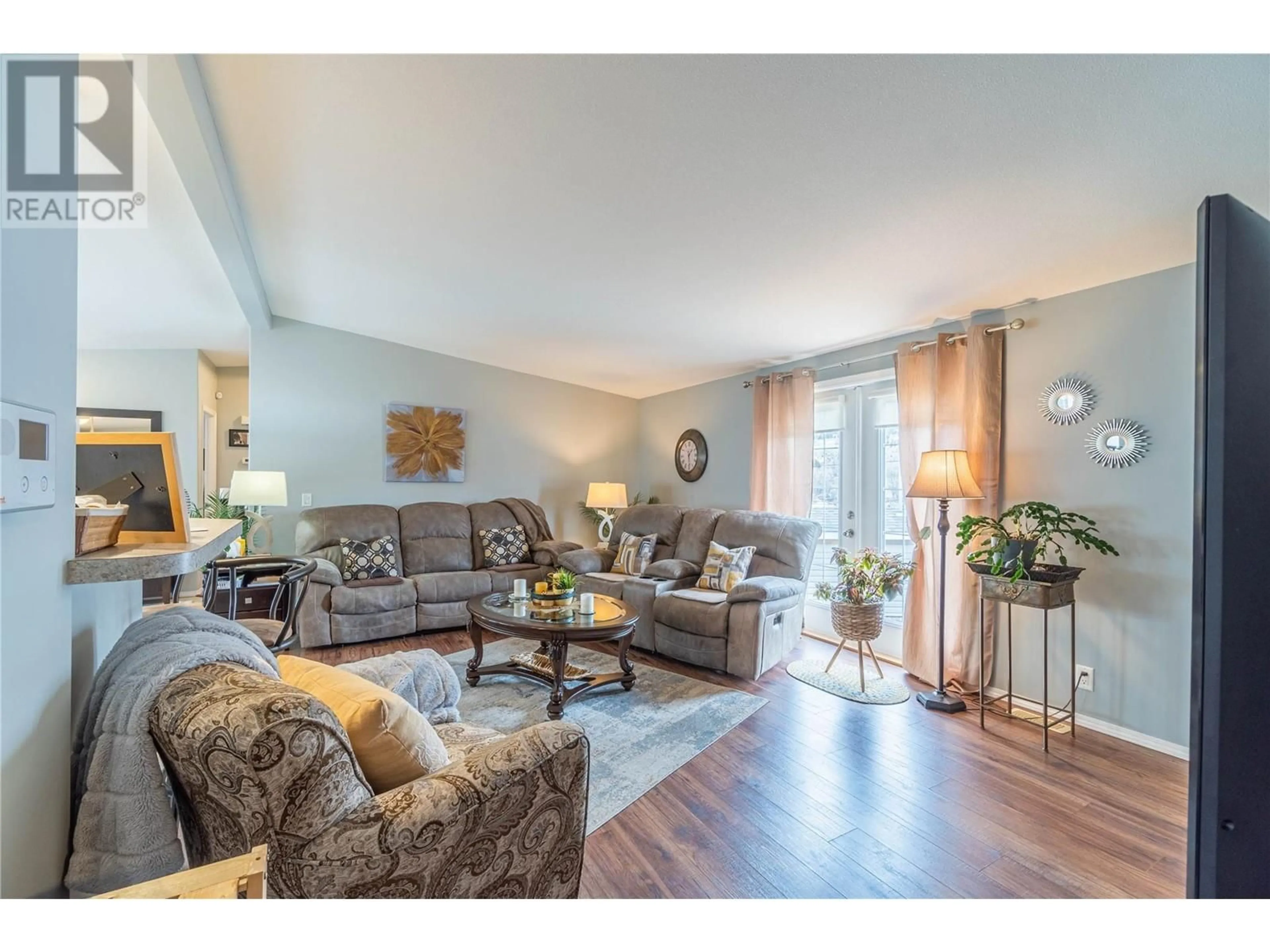 Living room with furniture, wood/laminate floor for 768 SHUSWAP Road E Unit# 1, Kamloops British Columbia V2H0A4