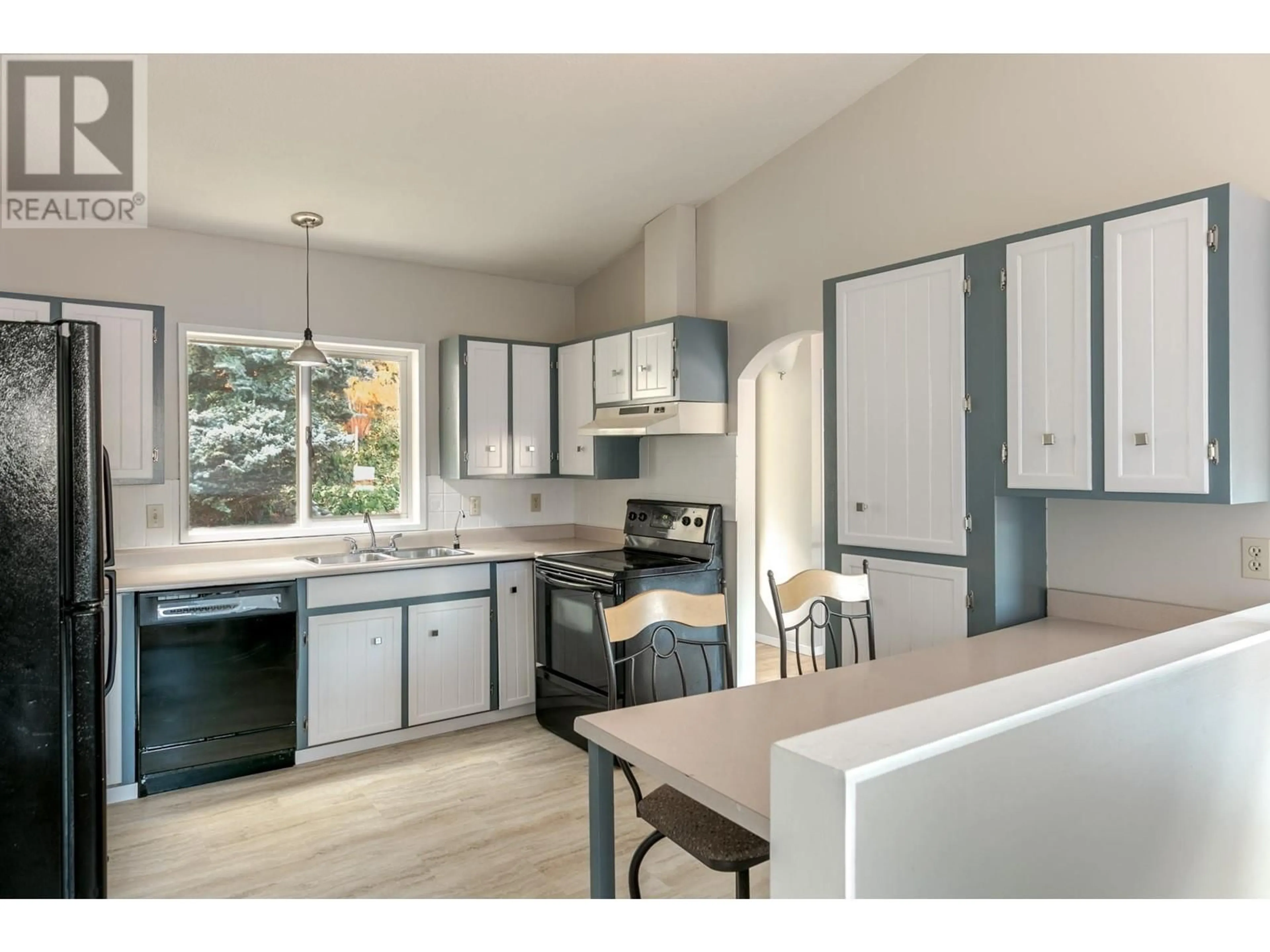 Open concept kitchen, wood/laminate floor for 15069 Old Mission Road, Lake Country British Columbia V4V2A9