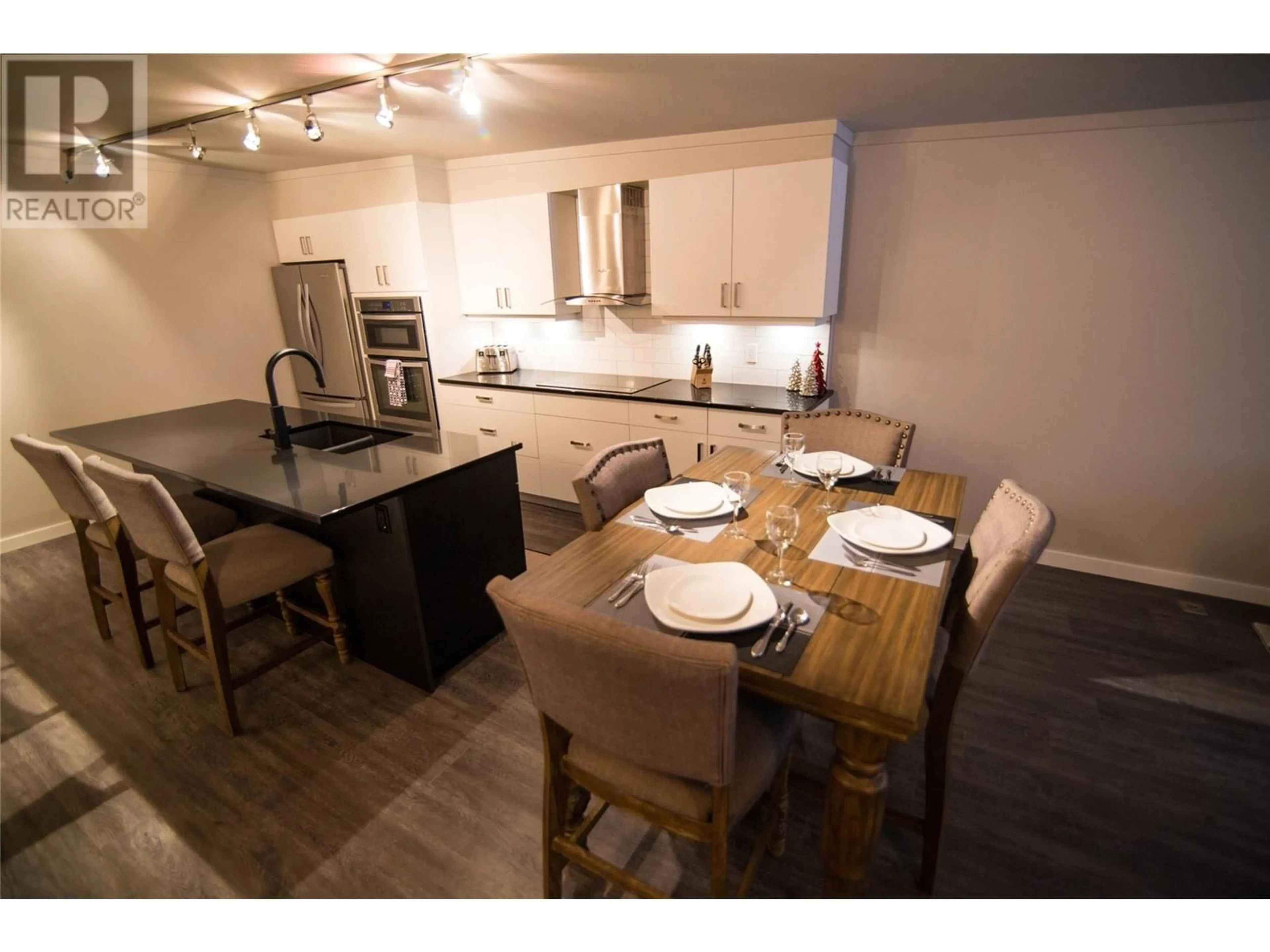 Open concept kitchen, wood/laminate floor for 103B 1240 Powerhouse Road, Revelstoke British Columbia V0E2S0