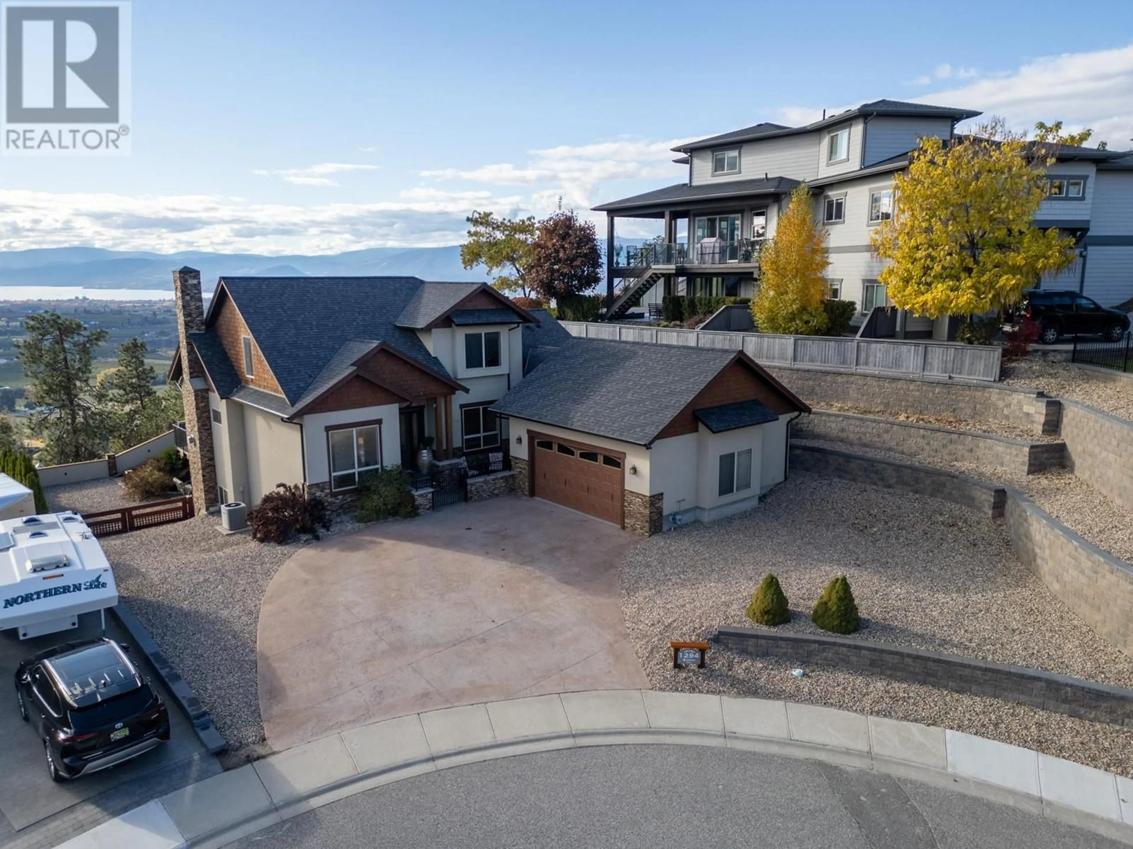 A pic from outside/outdoor area/front of a property/back of a property/a pic from drone, mountain view for 1294 Samurai Court, Kelowna British Columbia V1P1S2