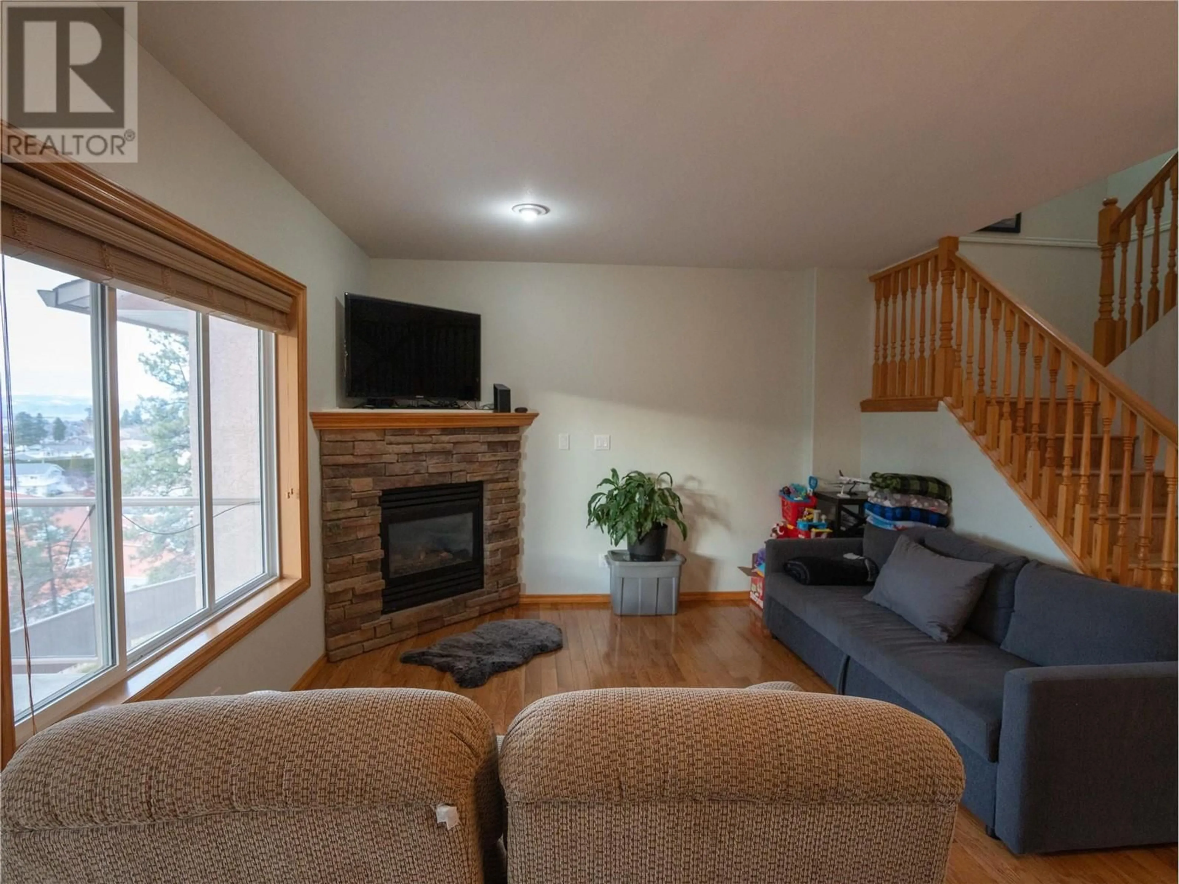 Living room with furniture, wood/laminate floor for 705 Balsam Avenue Unit# 116, Penticton British Columbia V2A9B7