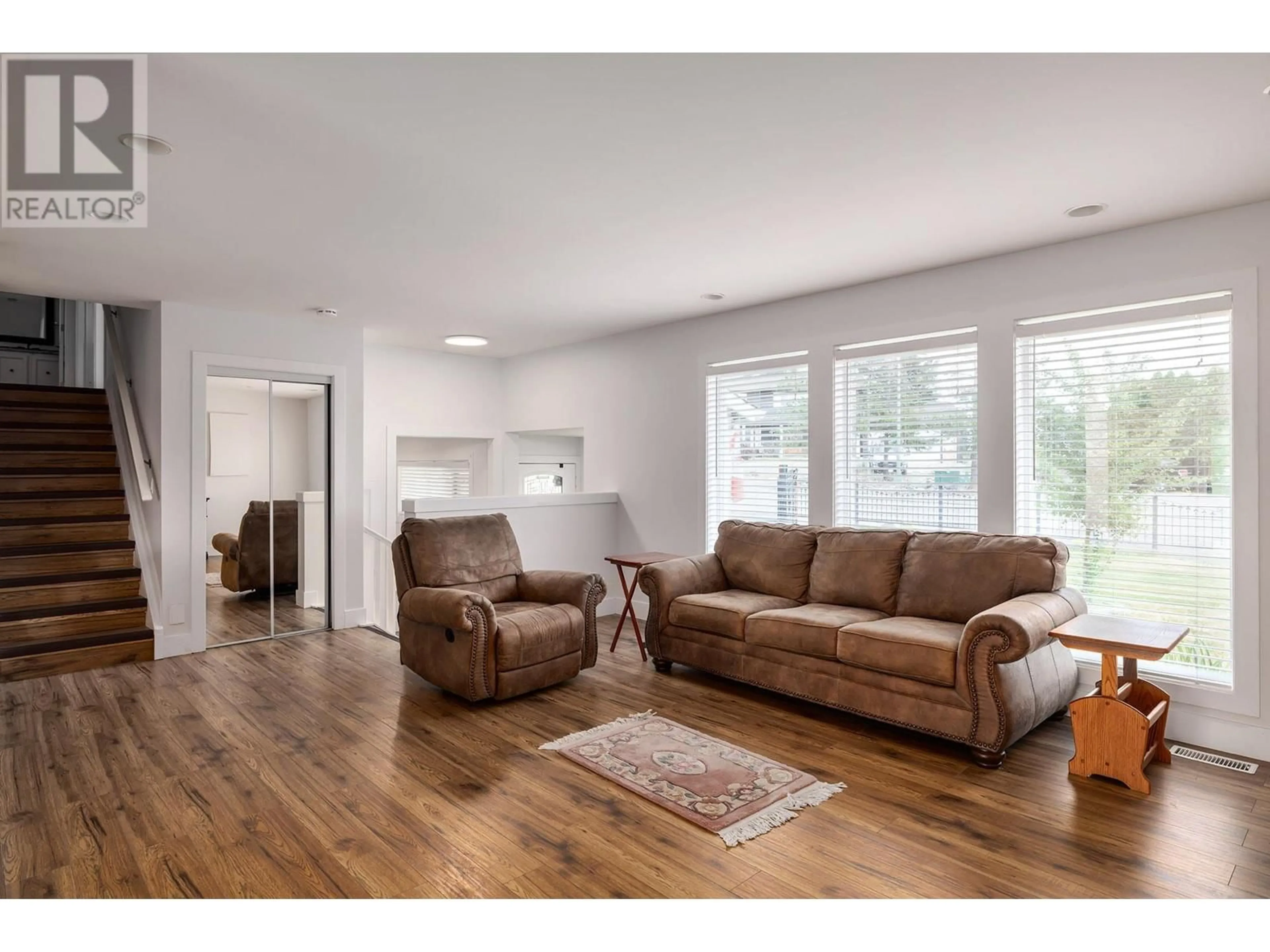 Living room with furniture, wood/laminate floor for 2571 Pineridge Place, West Kelowna British Columbia V4T2J7