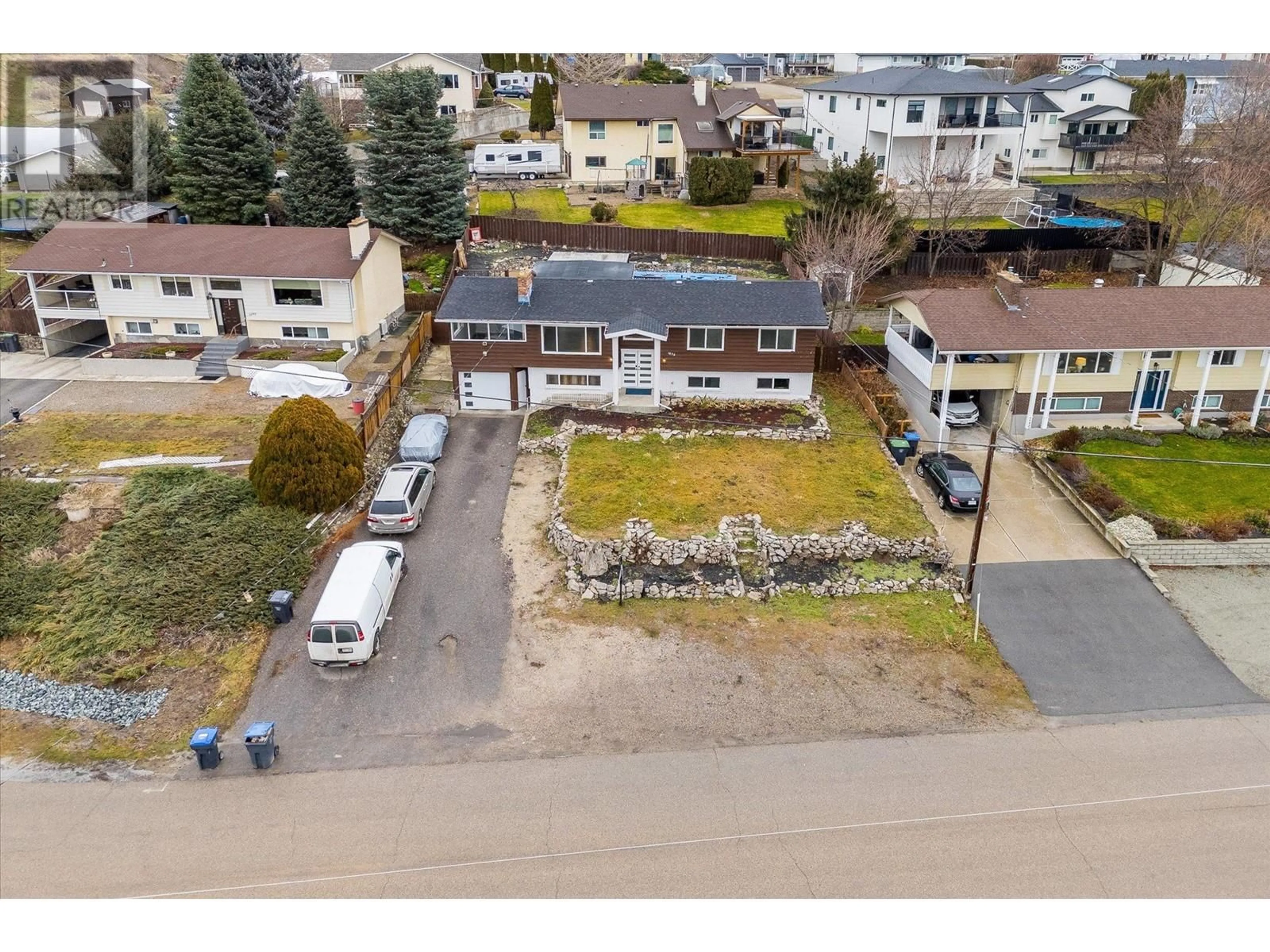 A pic from outside/outdoor area/front of a property/back of a property/a pic from drone, street for 1075 Graf Road, Kelowna British Columbia V1P1B8