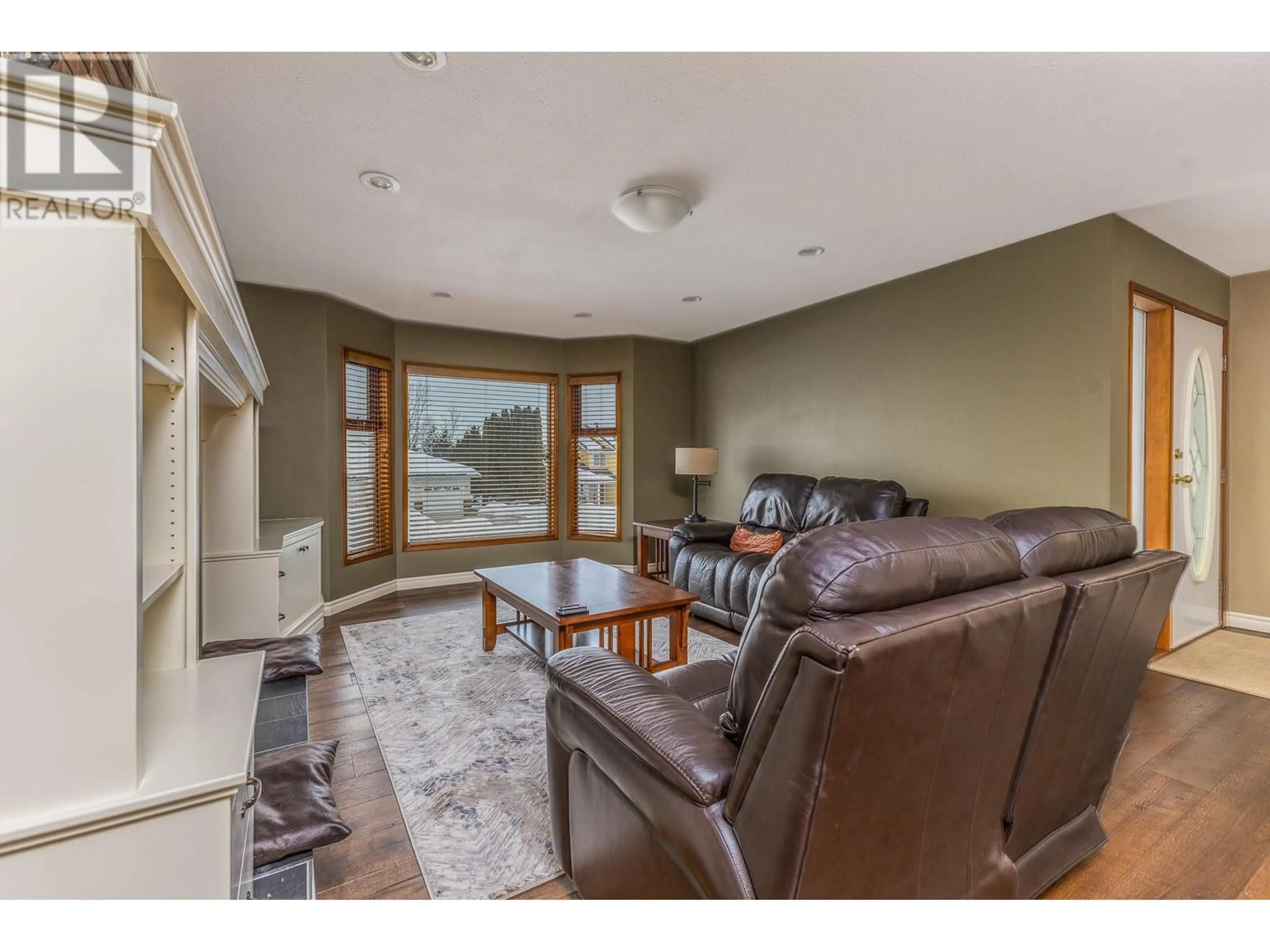 Living room with furniture, wood/laminate floor for 1660 18 Avenue SE, Salmon Arm British Columbia V1E2N1