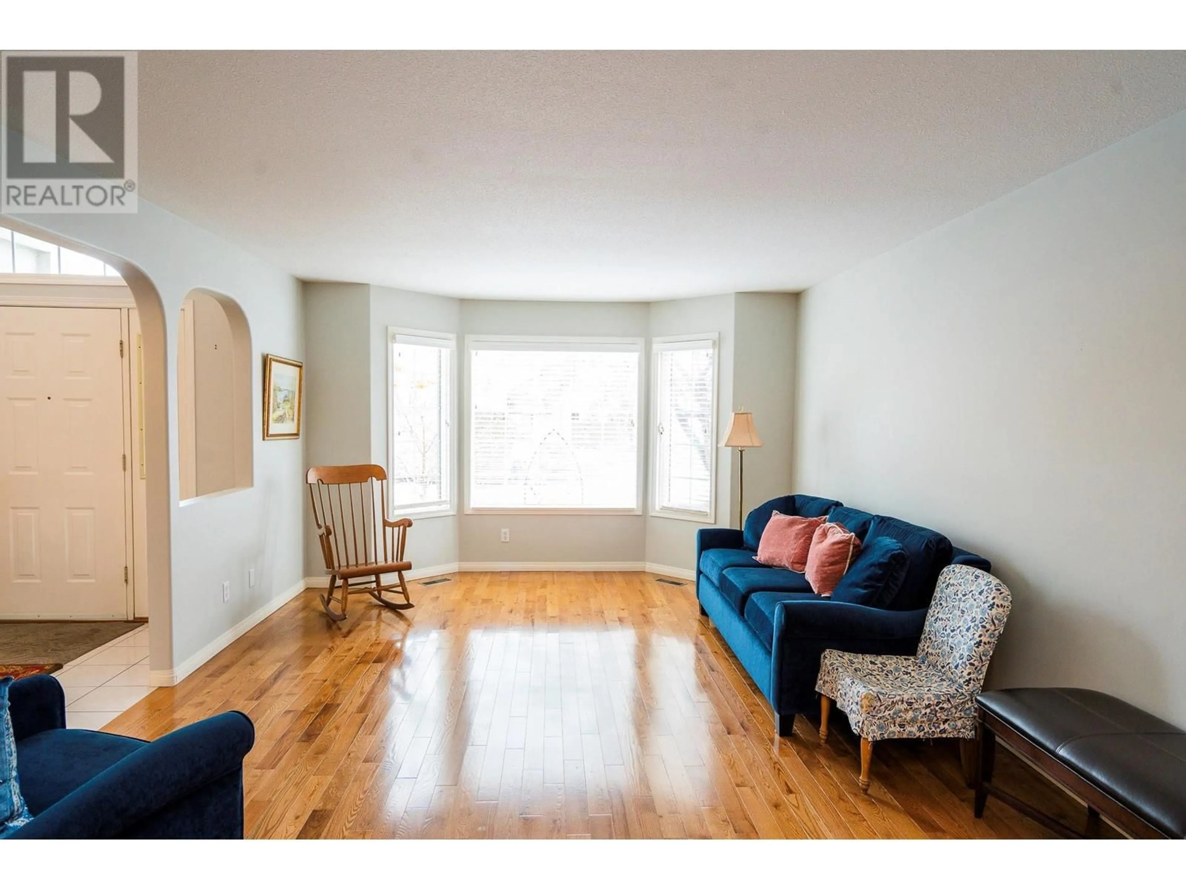 Living room with furniture, wood/laminate floor for 650 Lexington Drive Unit# 201, Kelowna British Columbia V1W3B6