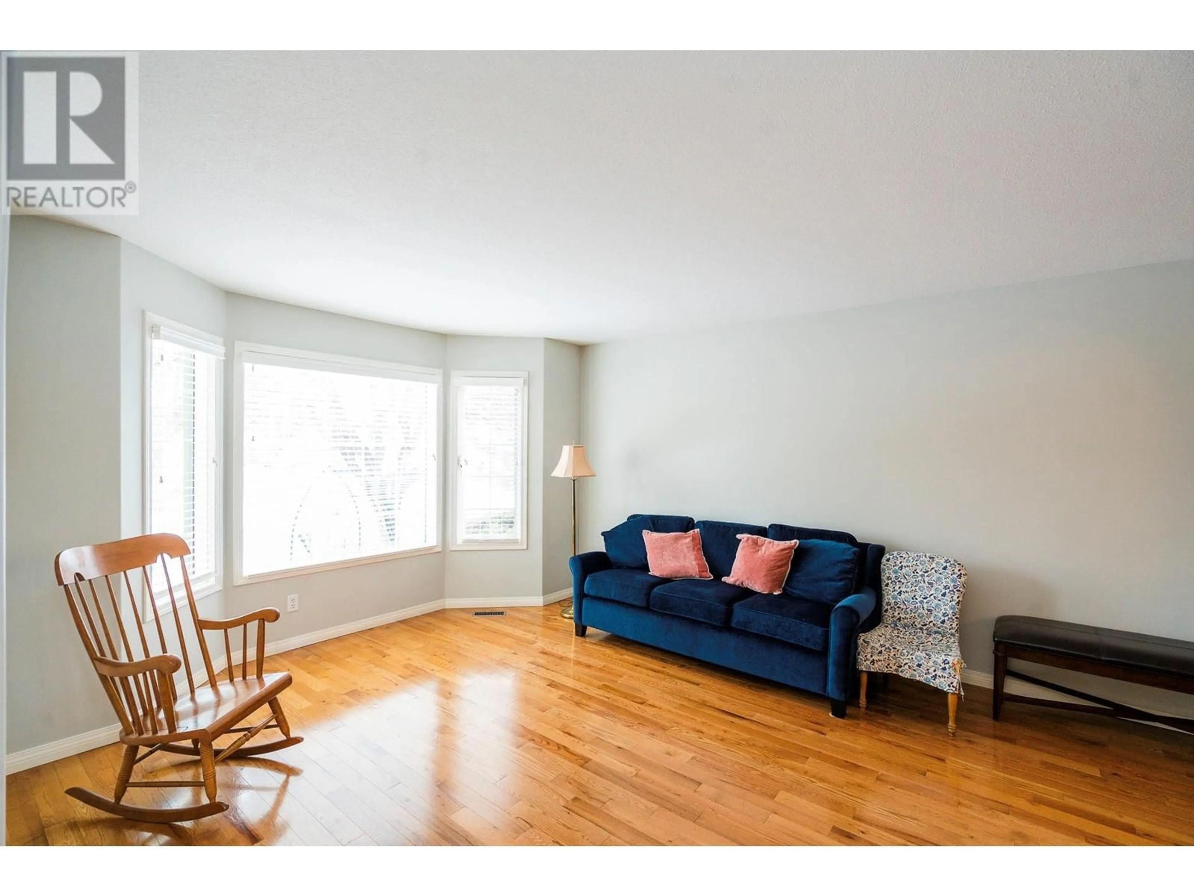 Living room with furniture, wood/laminate floor for 650 Lexington Drive Unit# 201, Kelowna British Columbia V1W3B6