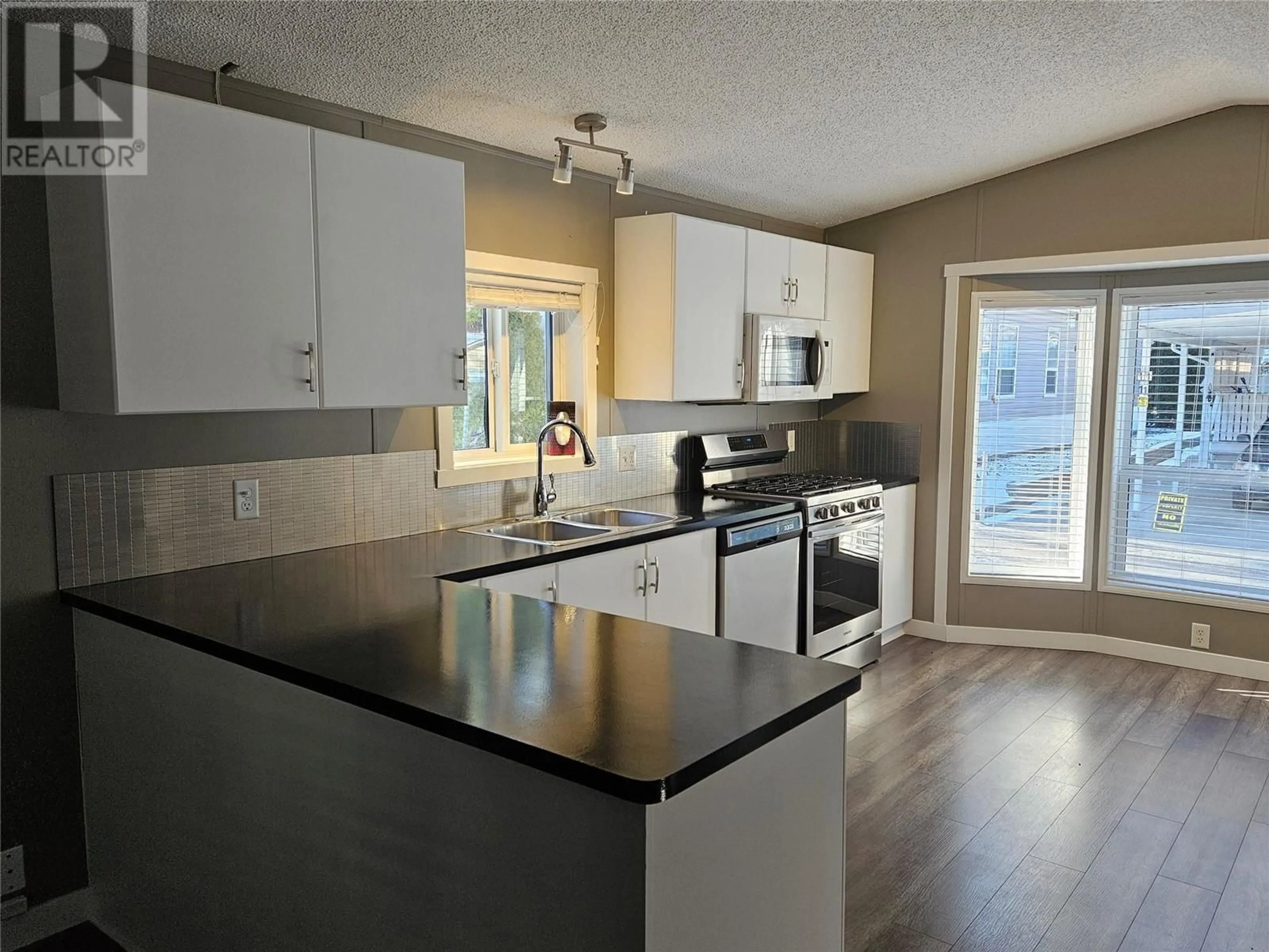 Open concept kitchen, wood/laminate floor for 8 - 1518 HWY 3A OTHER, Keremeos British Columbia V0X1N6