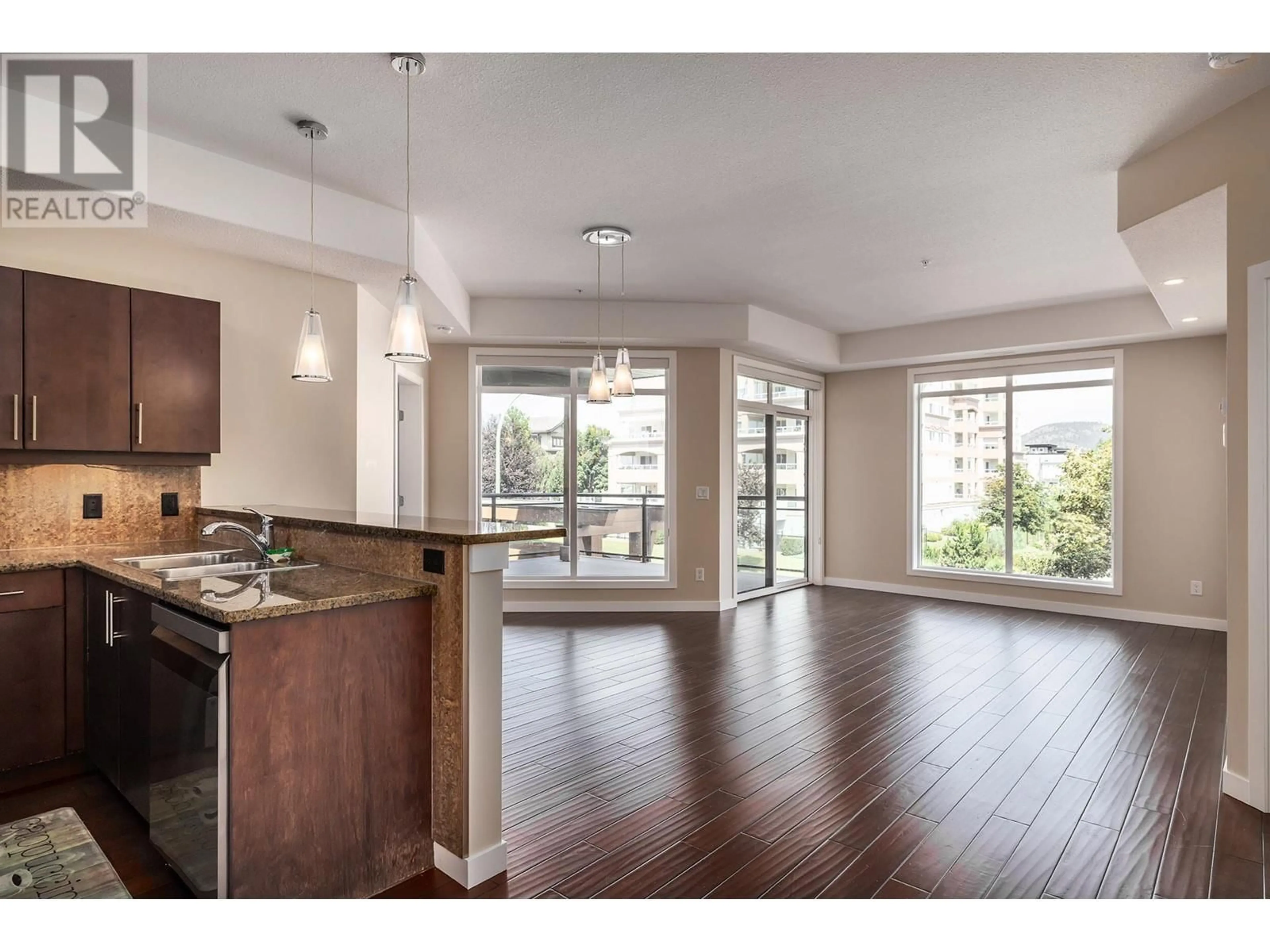 Open concept kitchen, wood/laminate floor for 207 - 2011 AGASSIZ ROAD, Kelowna British Columbia V1Y4S1