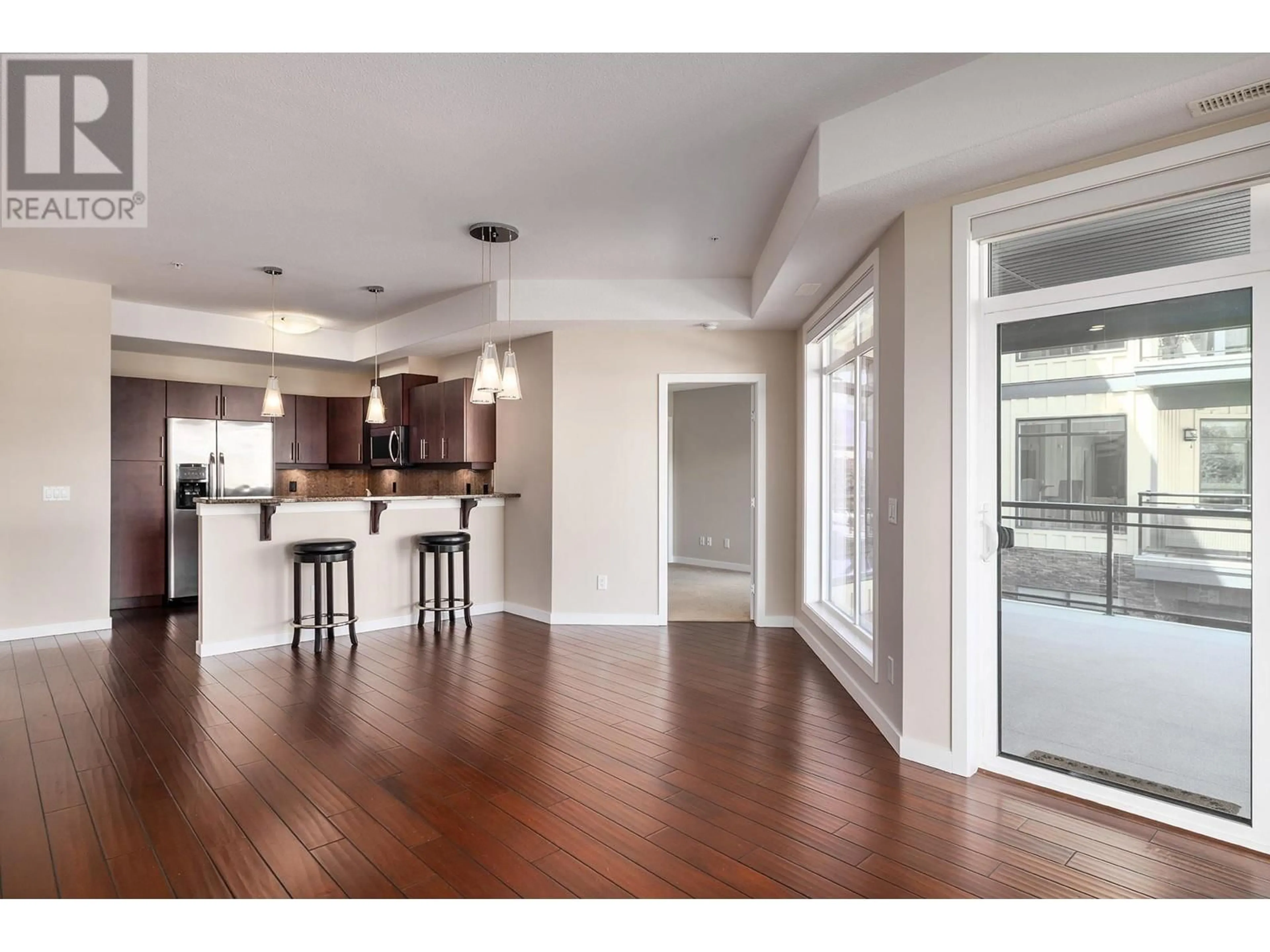 Open concept kitchen, wood/laminate floor for 207 - 2011 AGASSIZ ROAD, Kelowna British Columbia V1Y4S1