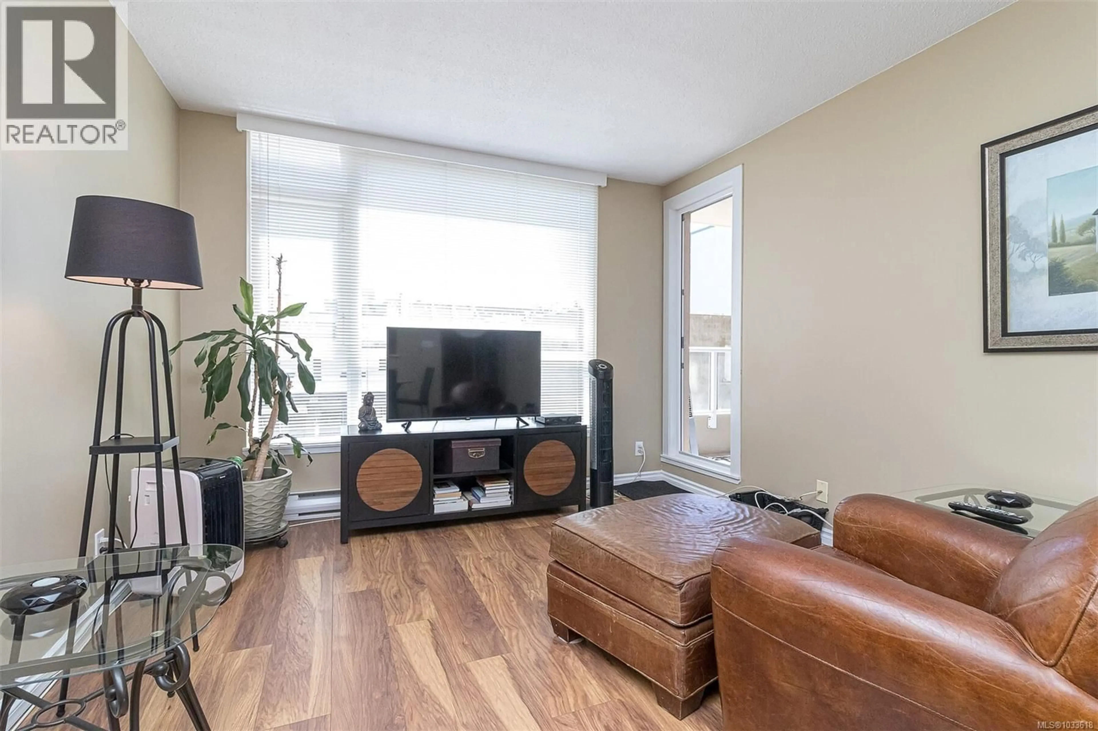 Living room with furniture, wood/laminate floor for 308 - 835 VIEW STREET, Victoria British Columbia V8W3W8