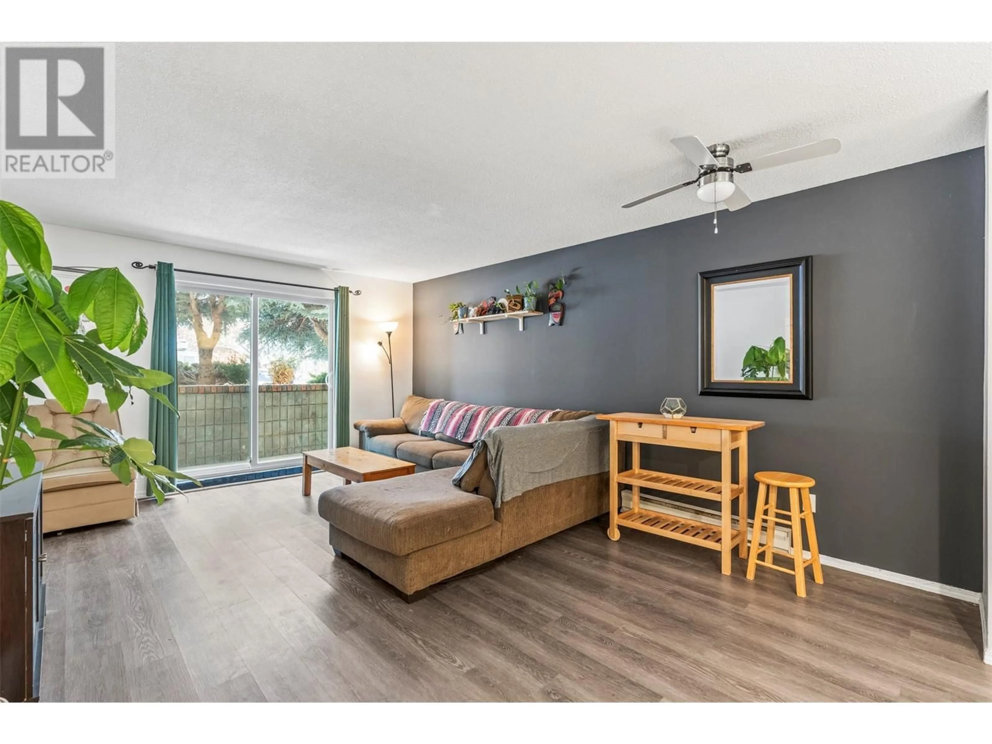 Living room with furniture, wood/laminate floor for 3304 35 Avenue Unit# 101, Vernon British Columbia V1T8M6