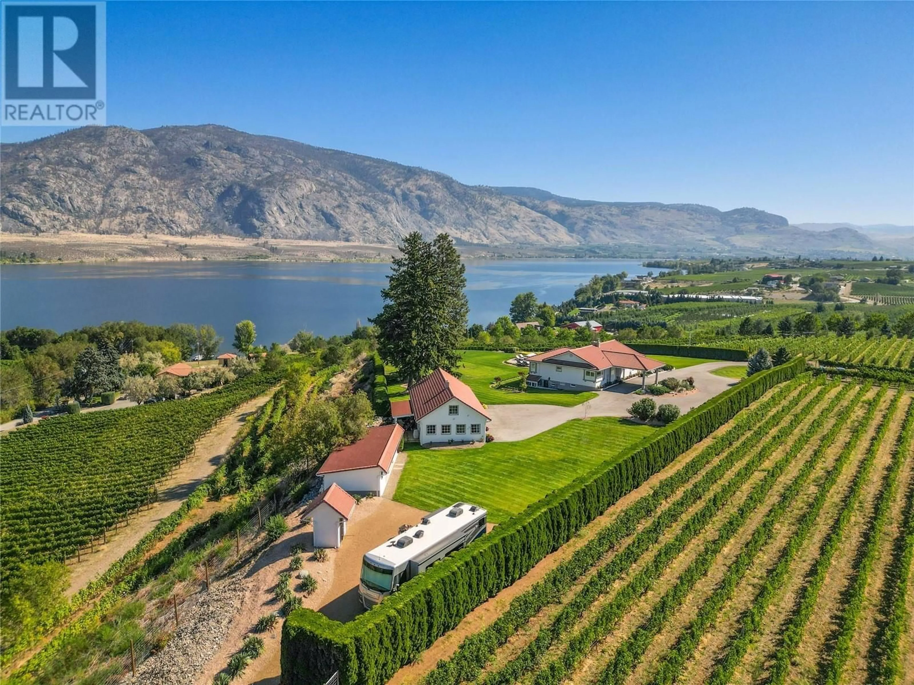 A pic from outside/outdoor area/front of a property/back of a property/a pic from drone, water/lake/river/ocean view for 13817 97 Highway, Osoyoos British Columbia V0H1V2