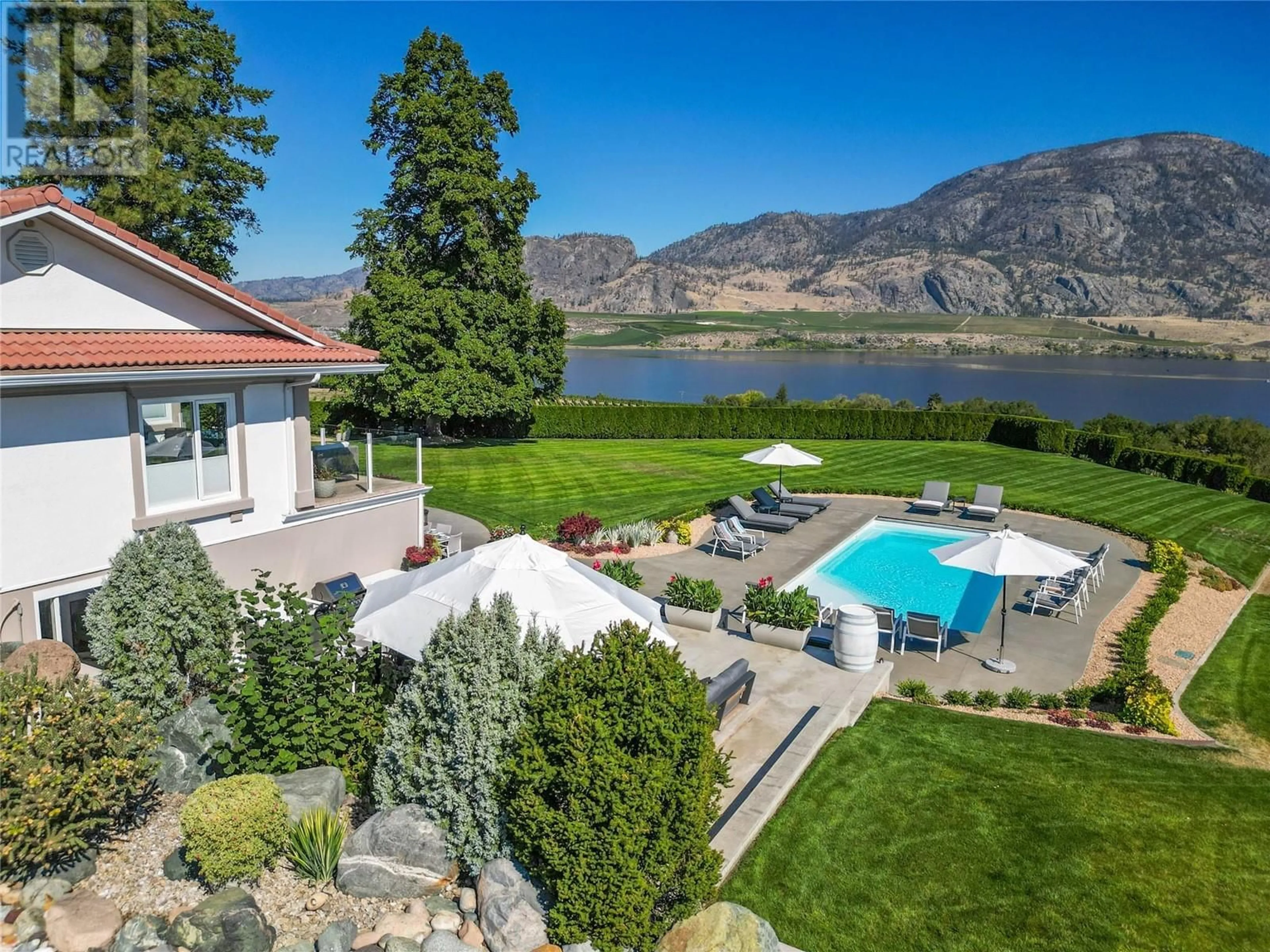 A pic from outside/outdoor area/front of a property/back of a property/a pic from drone, water/lake/river/ocean view for 13817 97 Highway, Osoyoos British Columbia V0H1V2