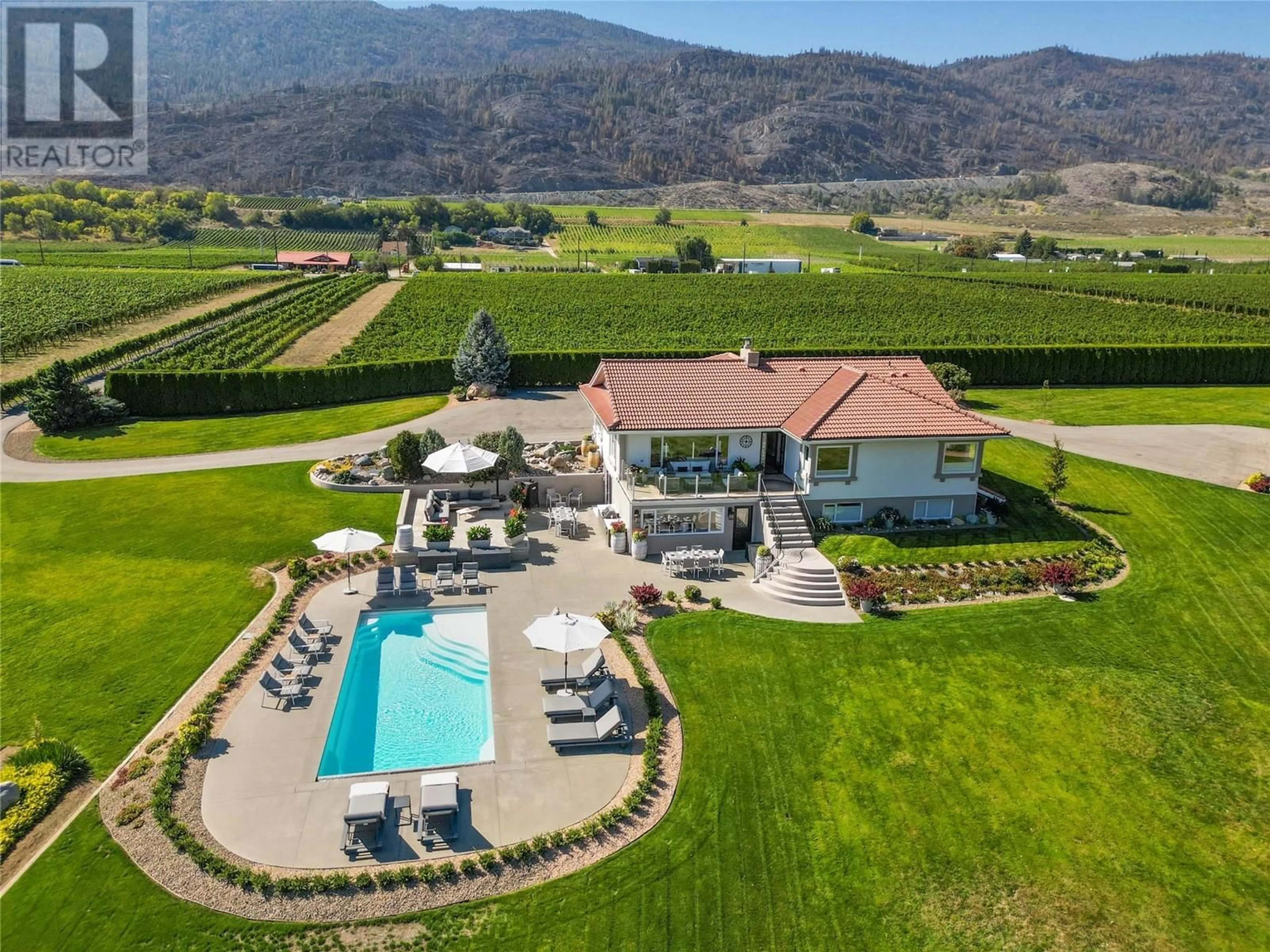 A pic from outside/outdoor area/front of a property/back of a property/a pic from drone, mountain view for 13817 97 Highway, Osoyoos British Columbia V0H1V2