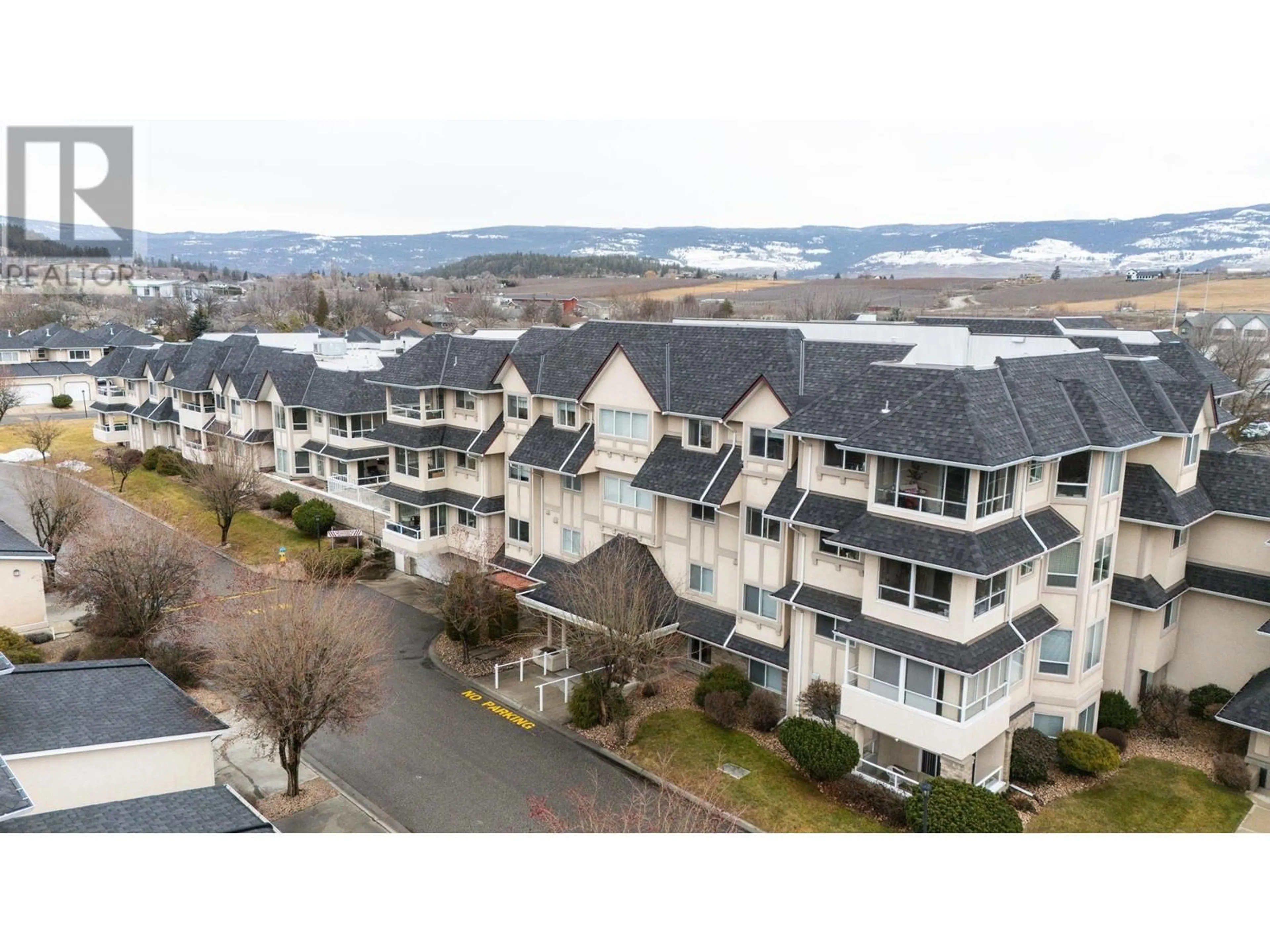 A pic from outside/outdoor area/front of a property/back of a property/a pic from drone, mountain view for 315 Whitman Road Unit# 205, Kelowna British Columbia V1V2J4