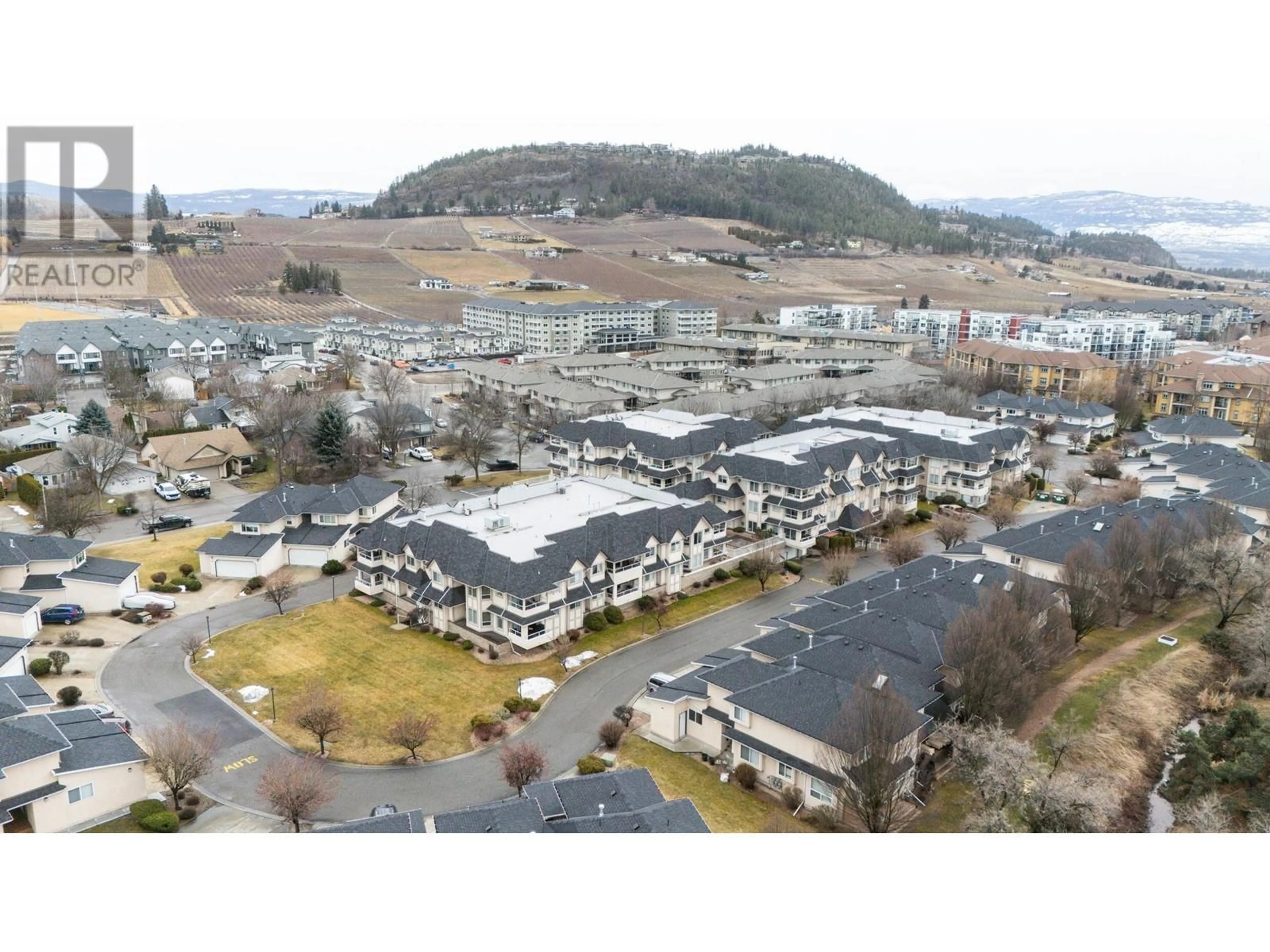 A pic from outside/outdoor area/front of a property/back of a property/a pic from drone, mountain view for 315 Whitman Road Unit# 205, Kelowna British Columbia V1V2J4