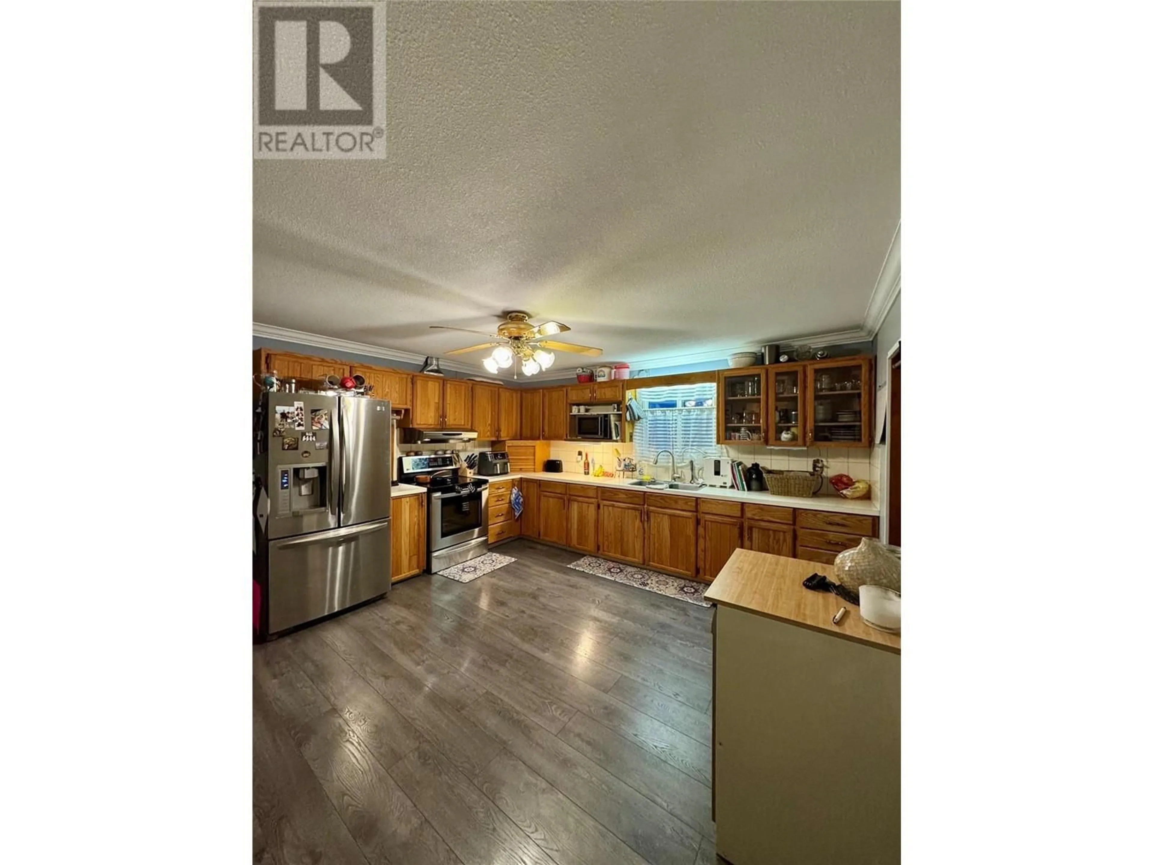 Open concept kitchen, wood/laminate floor for 2676 QUILCHENA AVENUE, Merritt British Columbia V1K1A4
