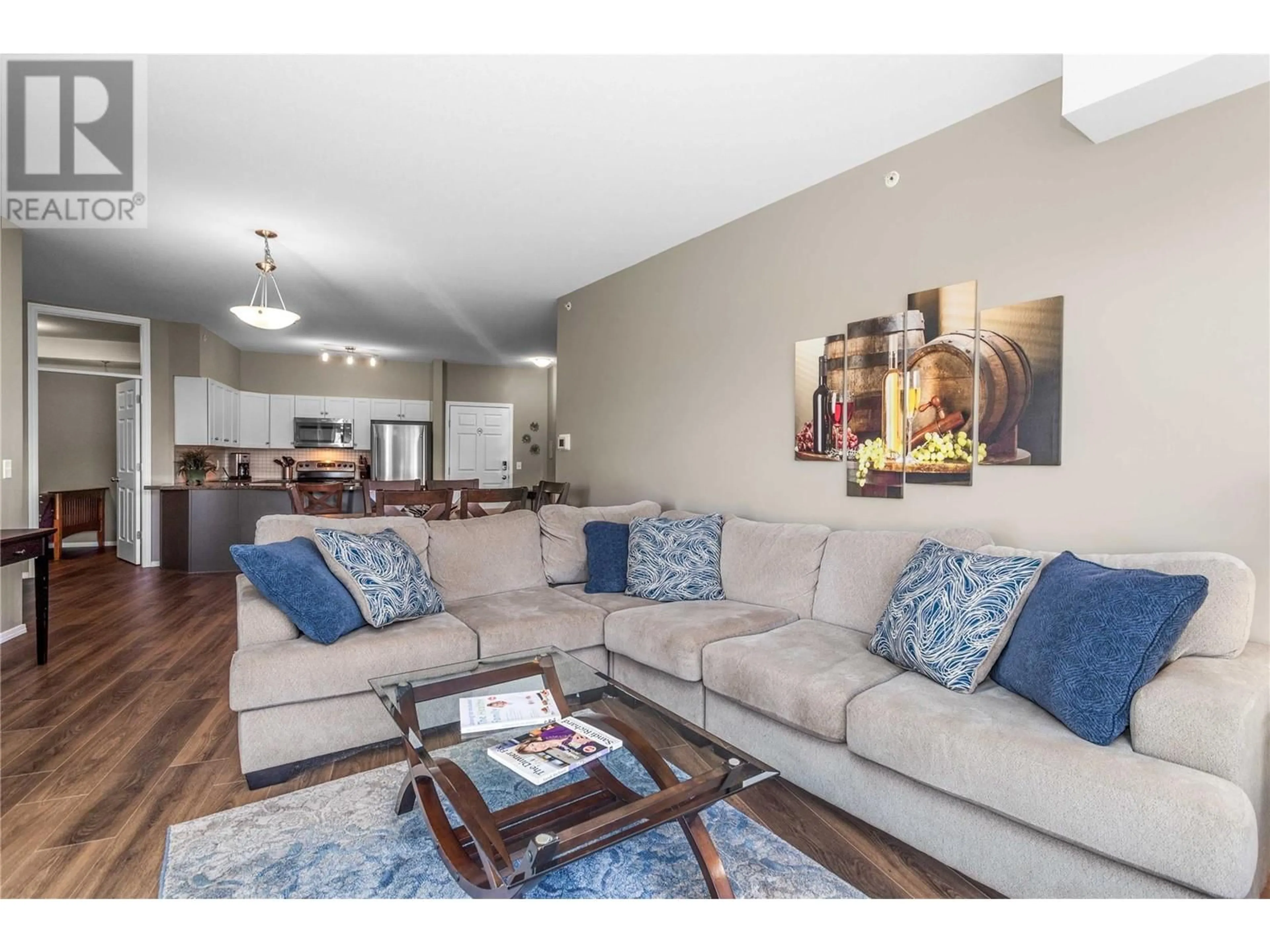 Living room with furniture, wood/laminate floor for 1873 Country Club Drive Unit# 2404, Kelowna British Columbia V1V2W6