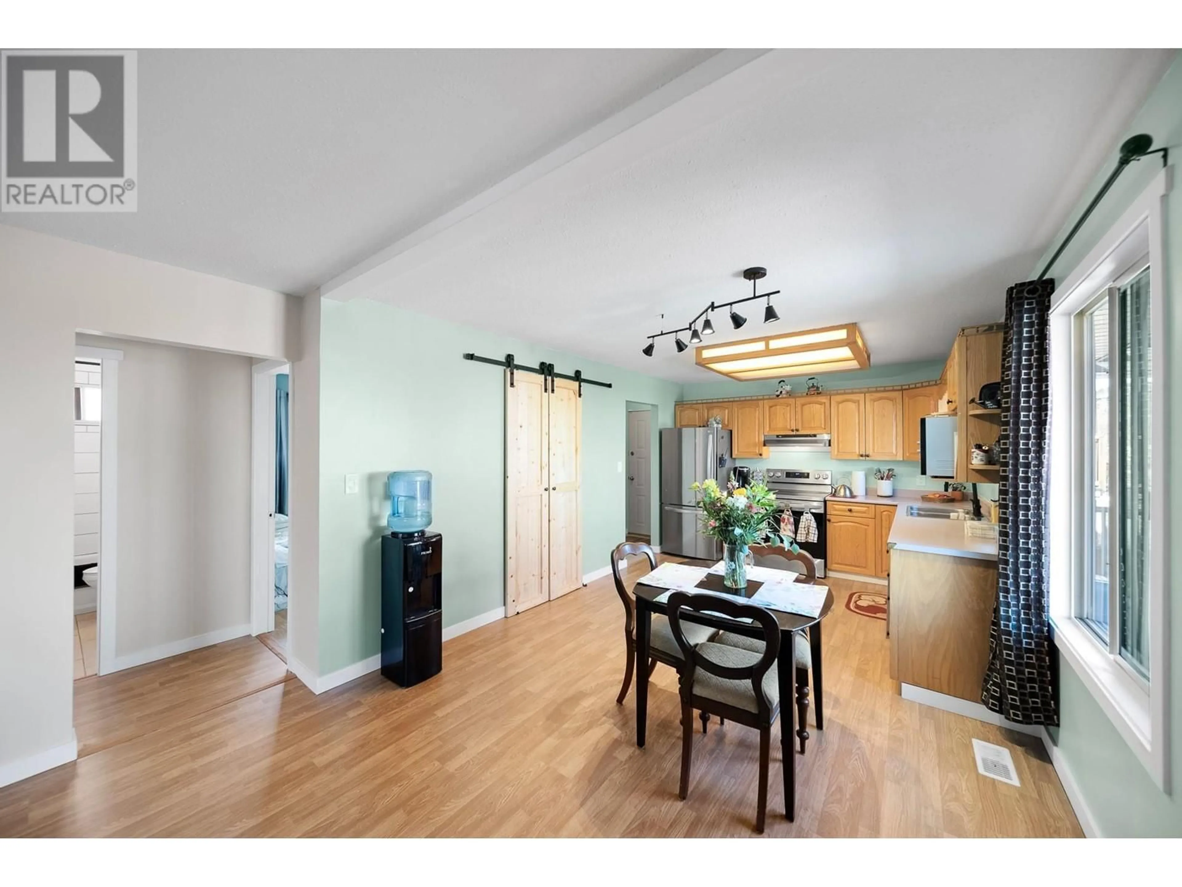 Open concept kitchen, wood/laminate floor for 2464 QUILCHENA AVENUE, Merritt British Columbia V1K1B8