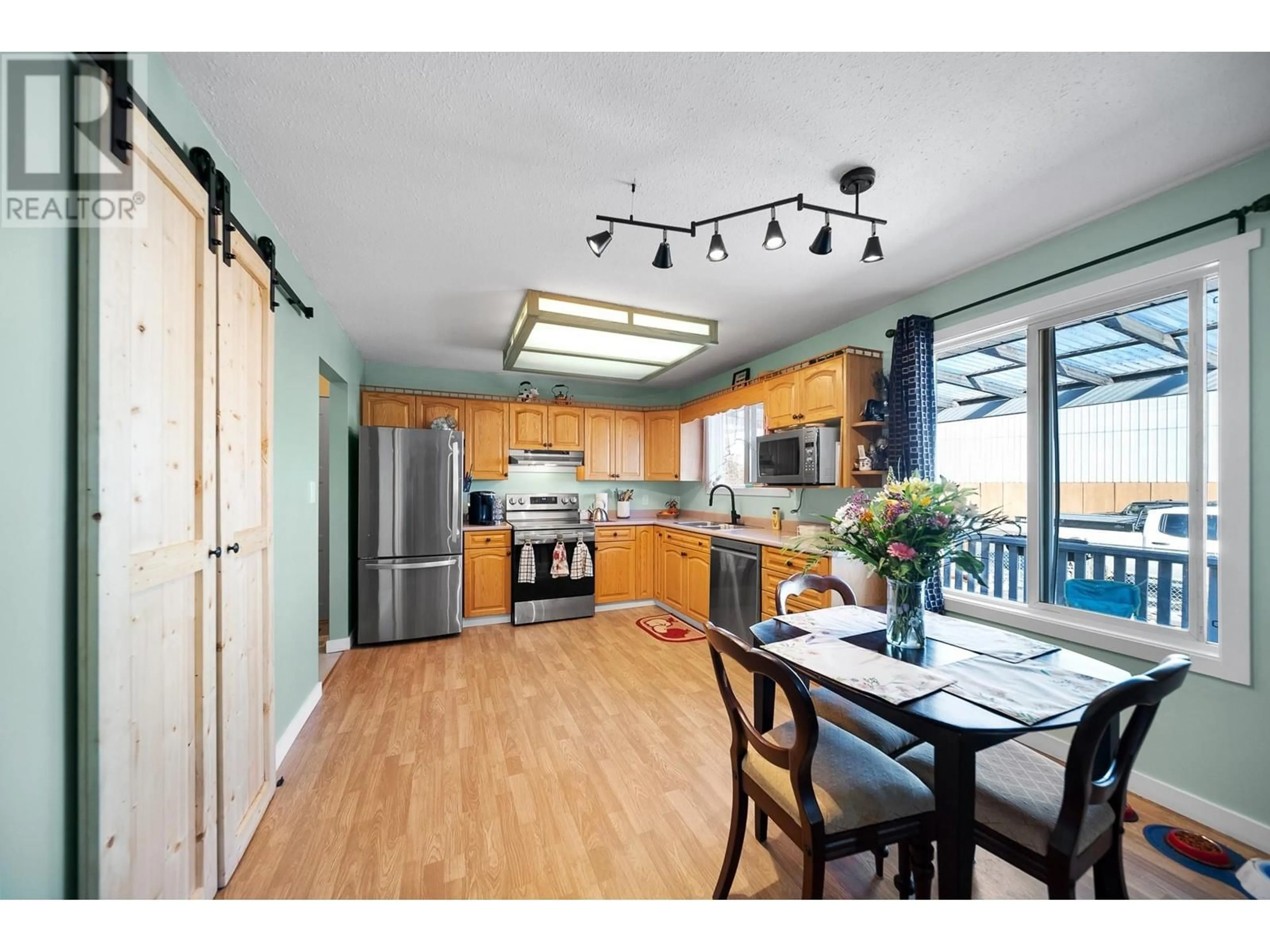 Open concept kitchen, wood/laminate floor for 2464 QUILCHENA AVENUE, Merritt British Columbia V1K1B8
