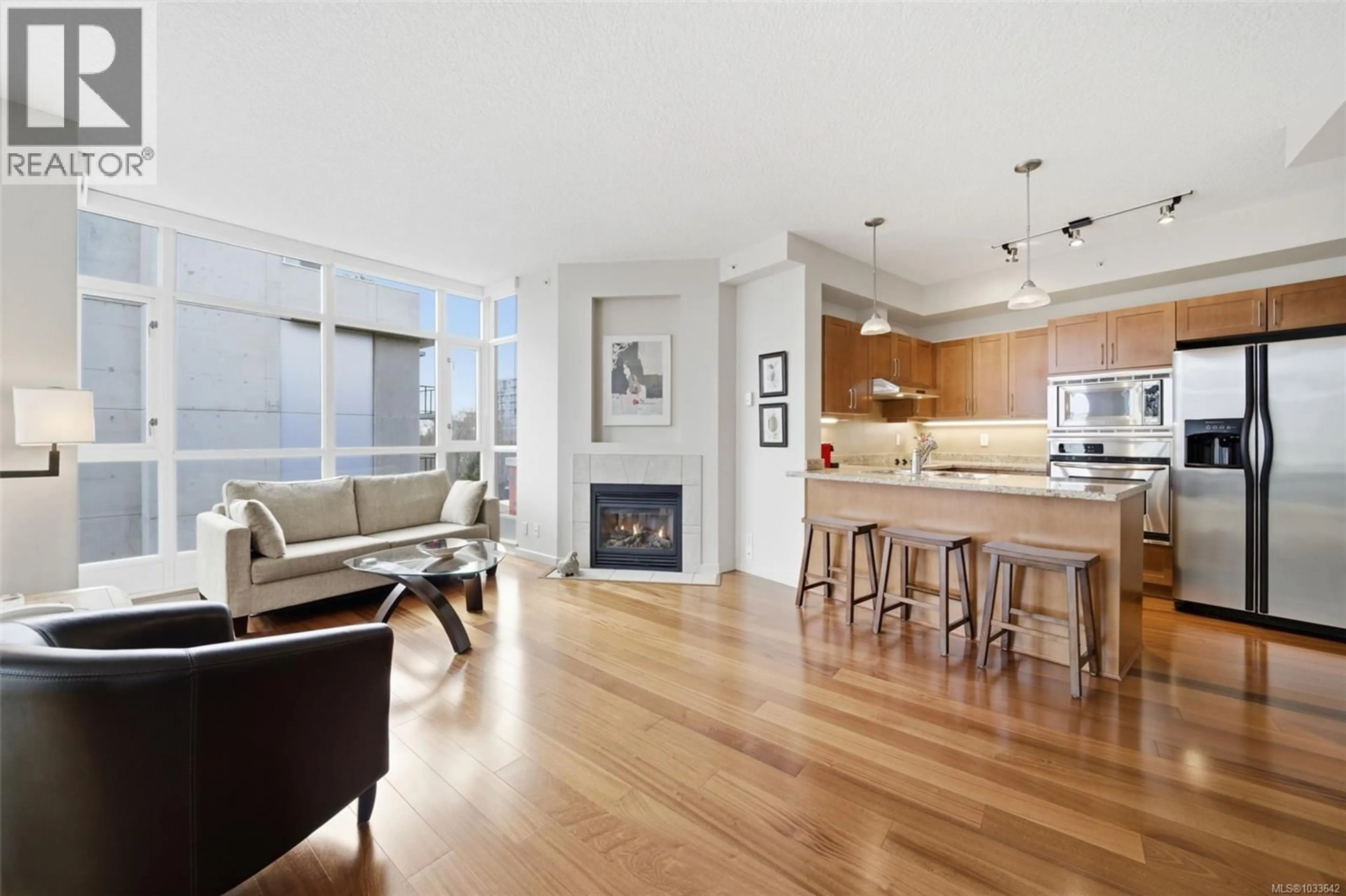 Open concept kitchen, wood/laminate floor for 609 - 827 FAIRFIELD ROAD, Victoria British Columbia V8V5B2