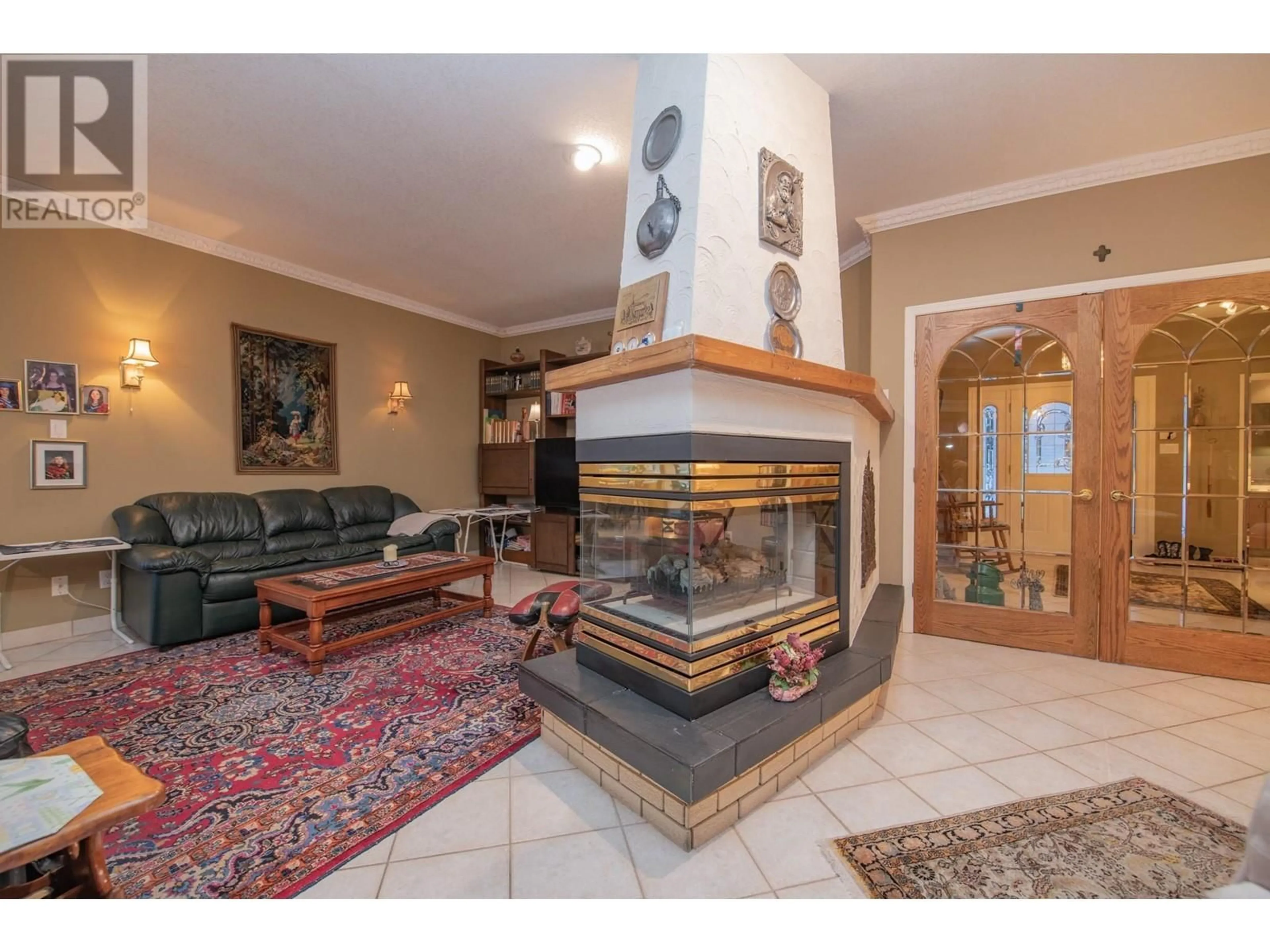 Living room with furniture, ceramic/tile floor for 6 9196 TRONSON ROAD, Vernon British Columbia V1H1E8