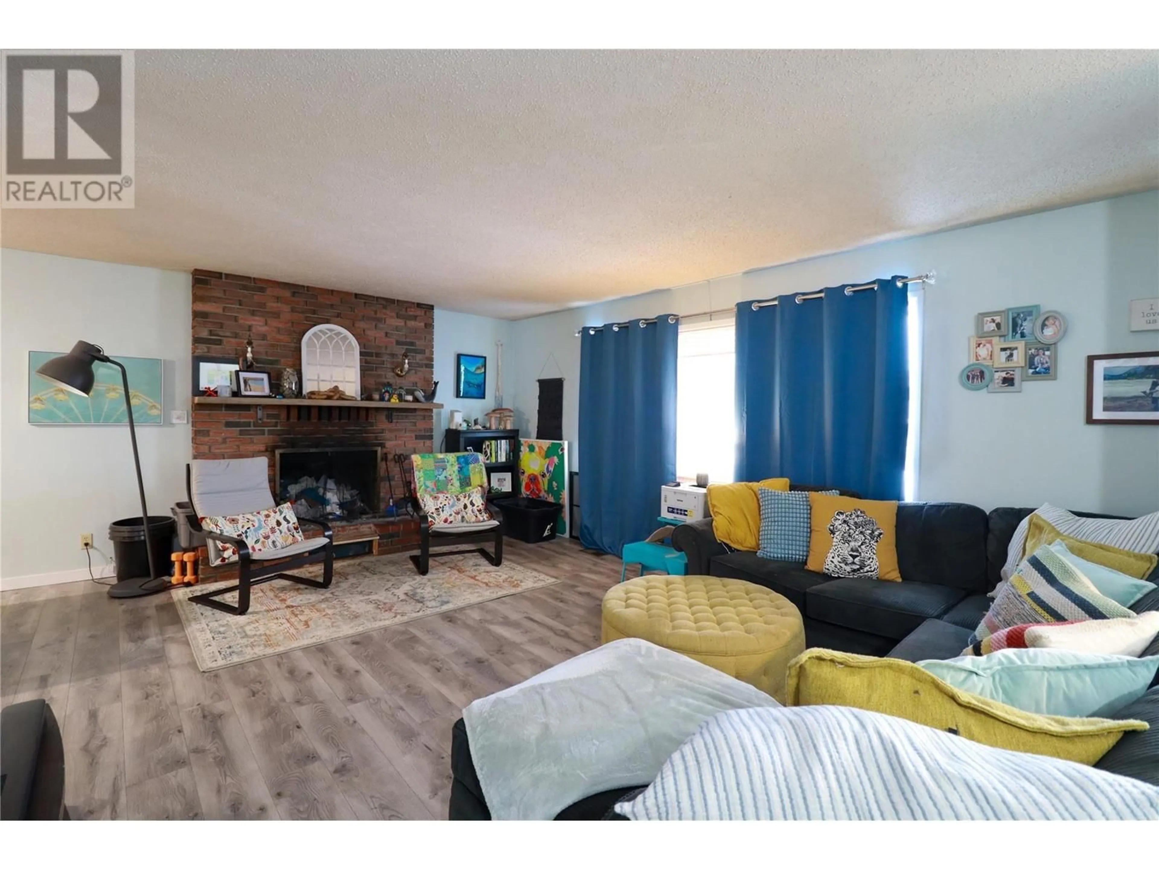 Living room with furniture, wood/laminate floor for 12115 MARSHALL CRESCENT, Summerland British Columbia V0H1Z5