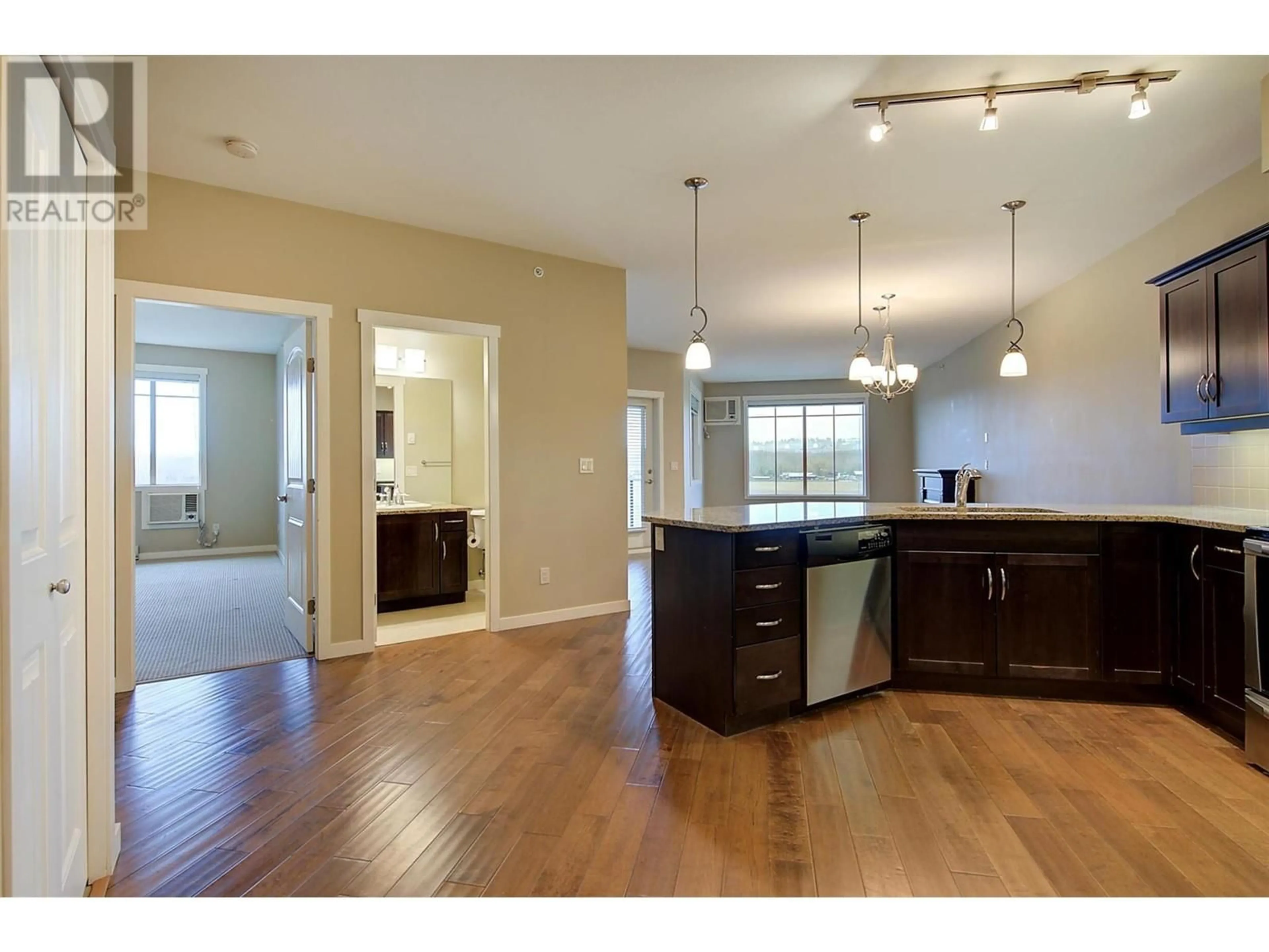 Open concept kitchen, wood/laminate floor for 3735 Casorso Road Unit# 408, Kelowna British Columbia V1W5G1