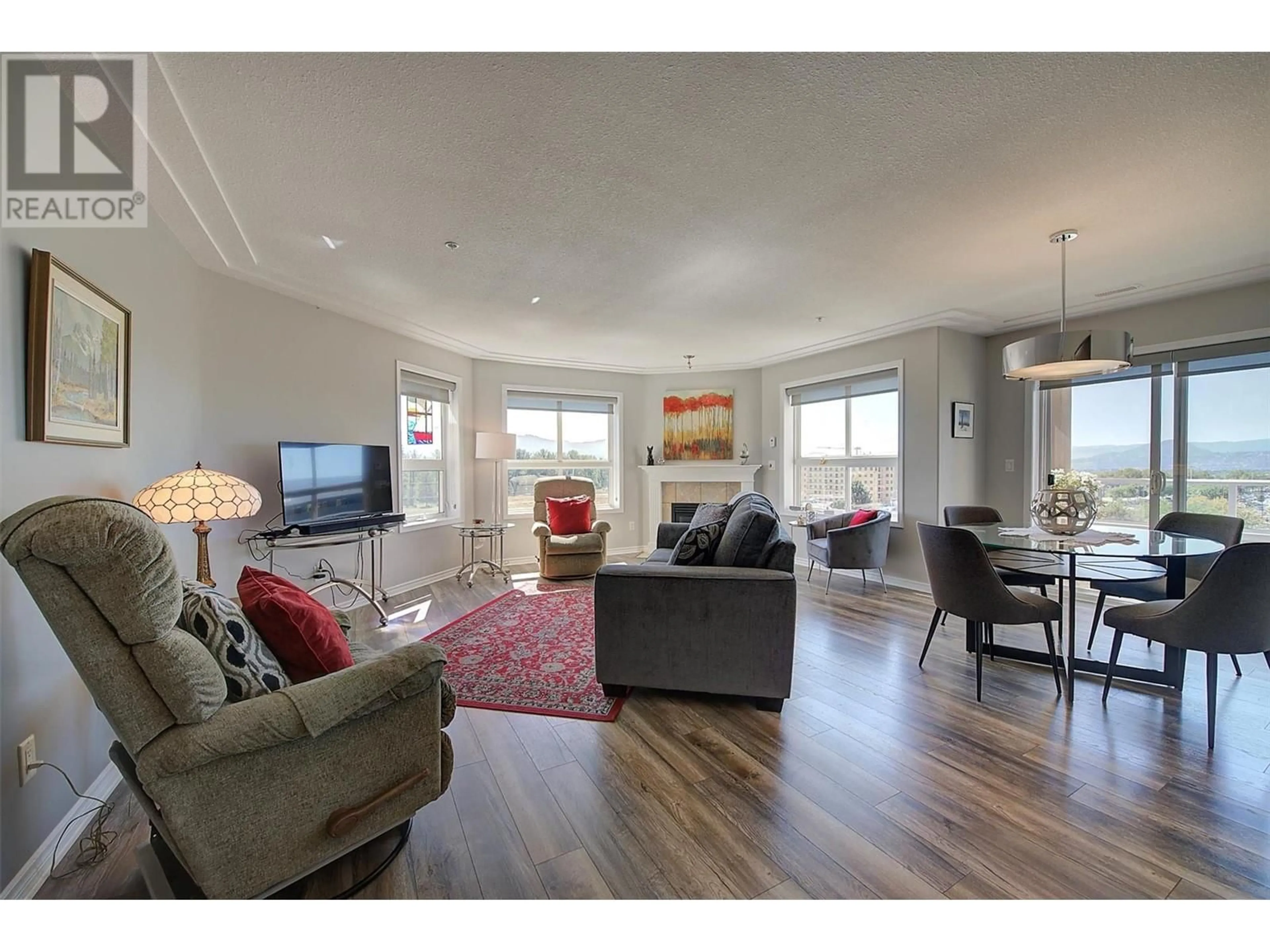 Living room with furniture, wood/laminate floor for 602 - 1967 UNDERHILL STREET, Kelowna British Columbia V1X8C9