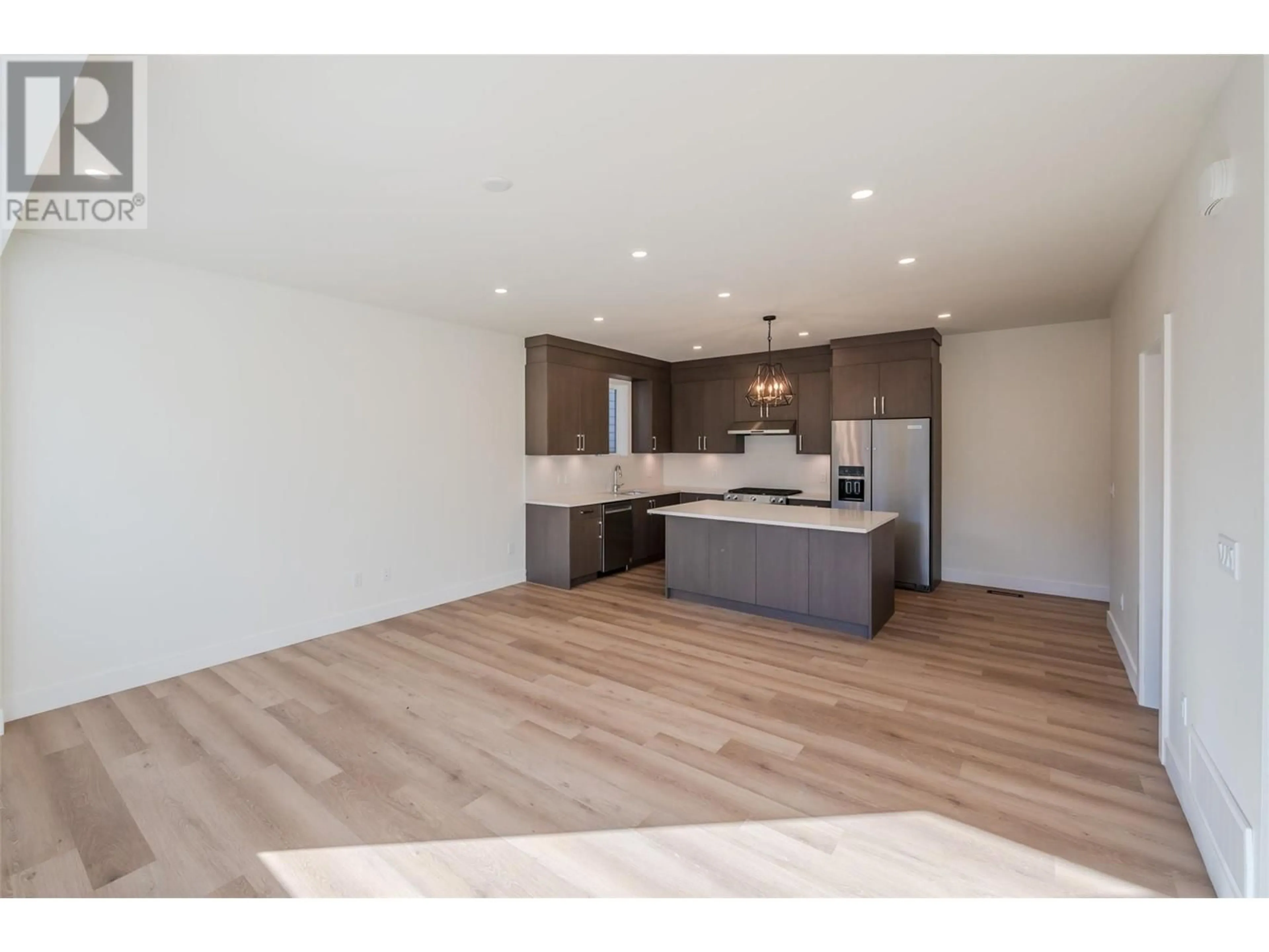 Open concept kitchen, wood/laminate floor for 1715 Fairford Drive Unit# 101, Penticton British Columbia V2A6C7