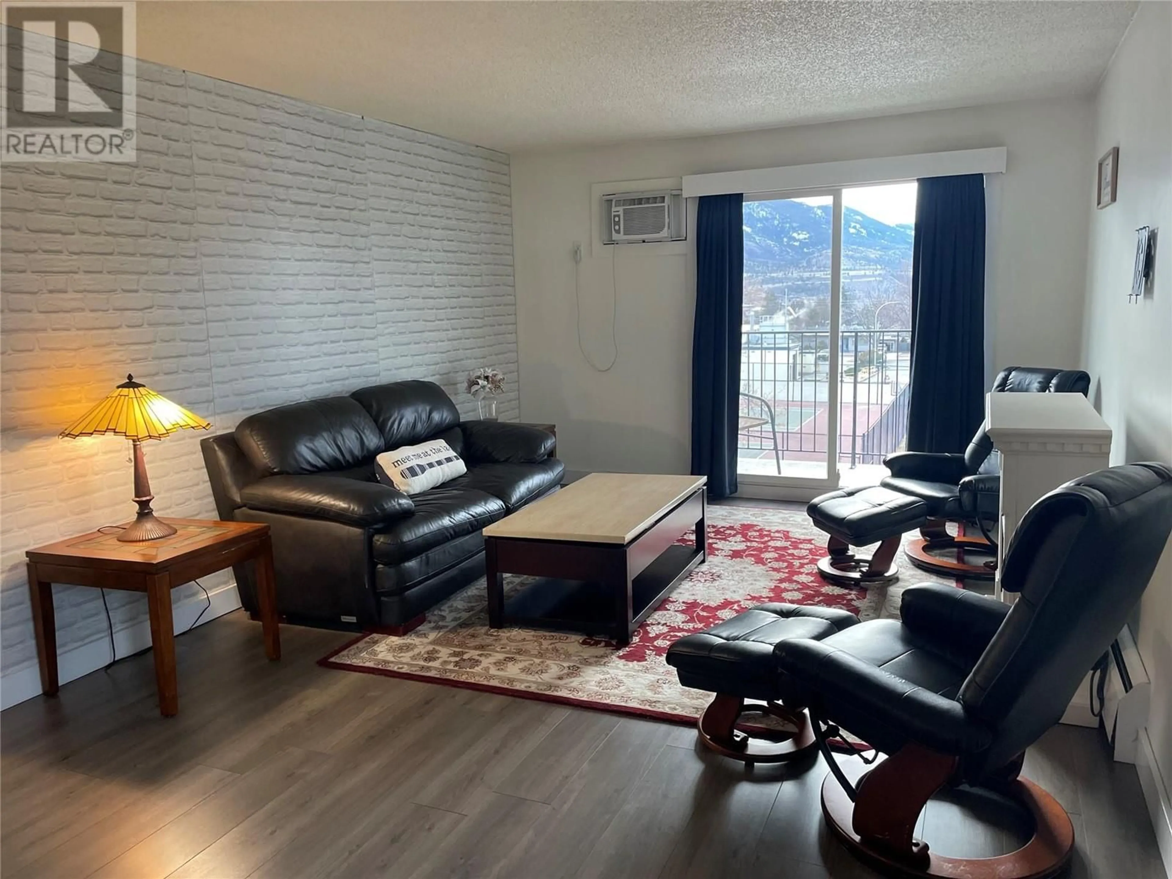 Living room with furniture, wood/laminate floor for 1300 Church Street Unit# 301, Penticton British Columbia V2A4R8