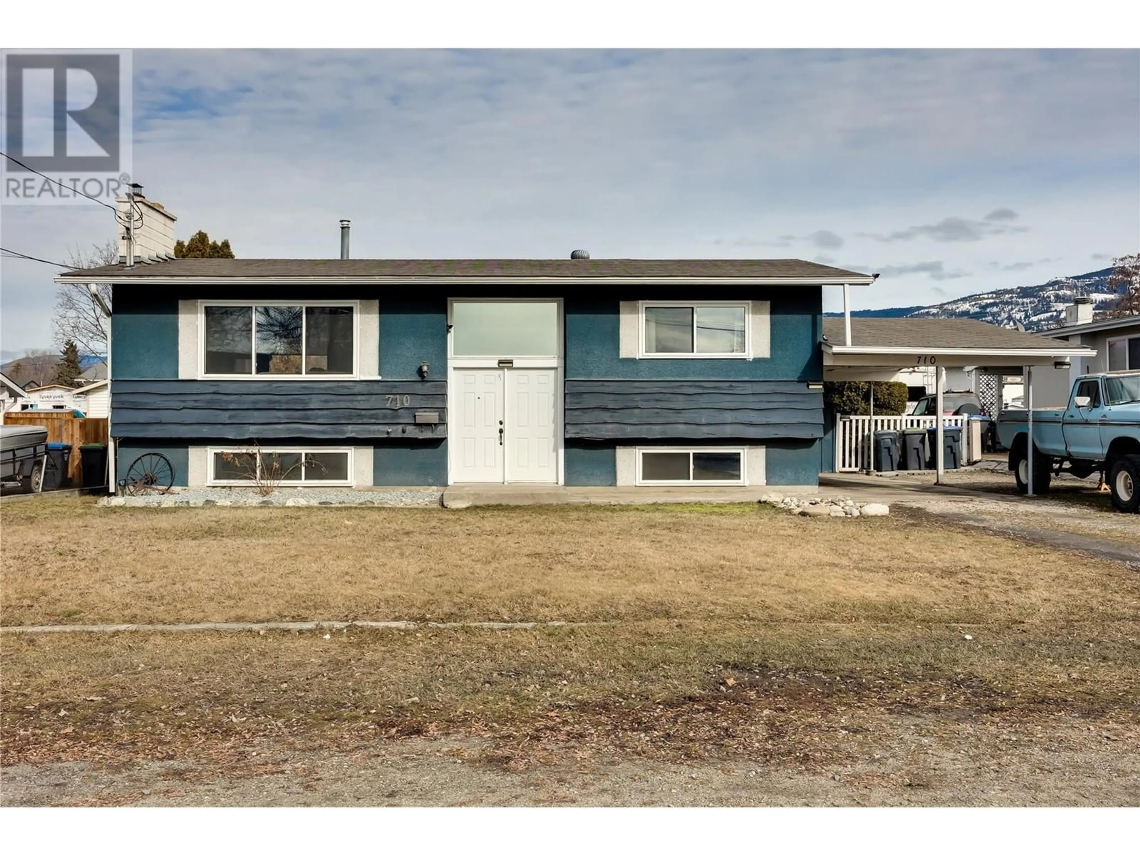 Home with vinyl exterior material, street for 710 Hollydell Road, Kelowna British Columbia V1X1L5