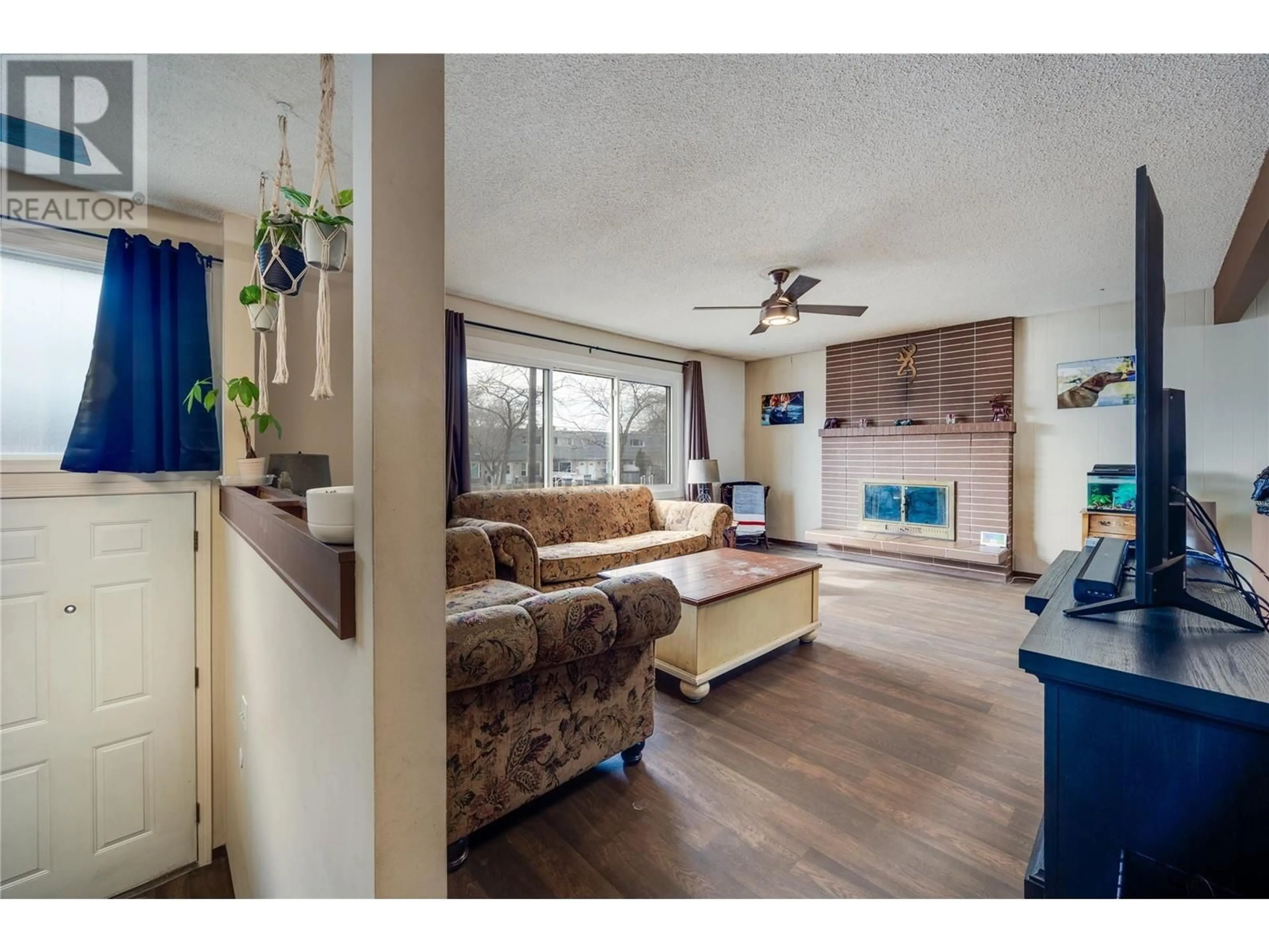 Open concept kitchen, wood/laminate floor for 710 Hollydell Road, Kelowna British Columbia V1X1L5