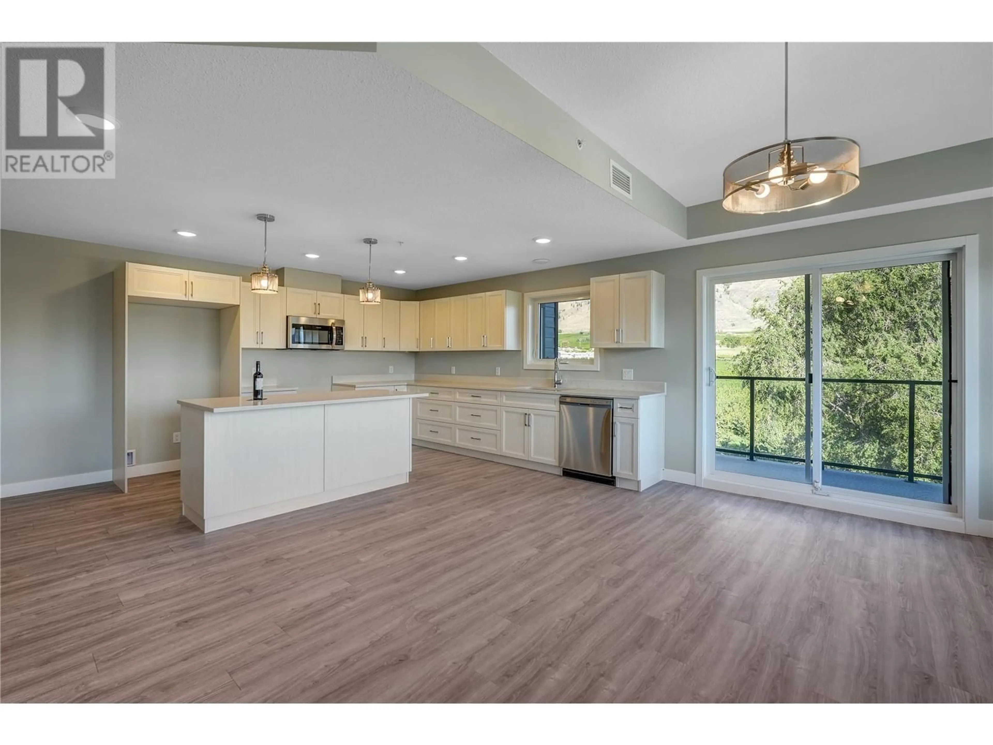Open concept kitchen, wood/laminate floor for 404 - 5620 51ST STREET, Osoyoos British Columbia V0H1V6