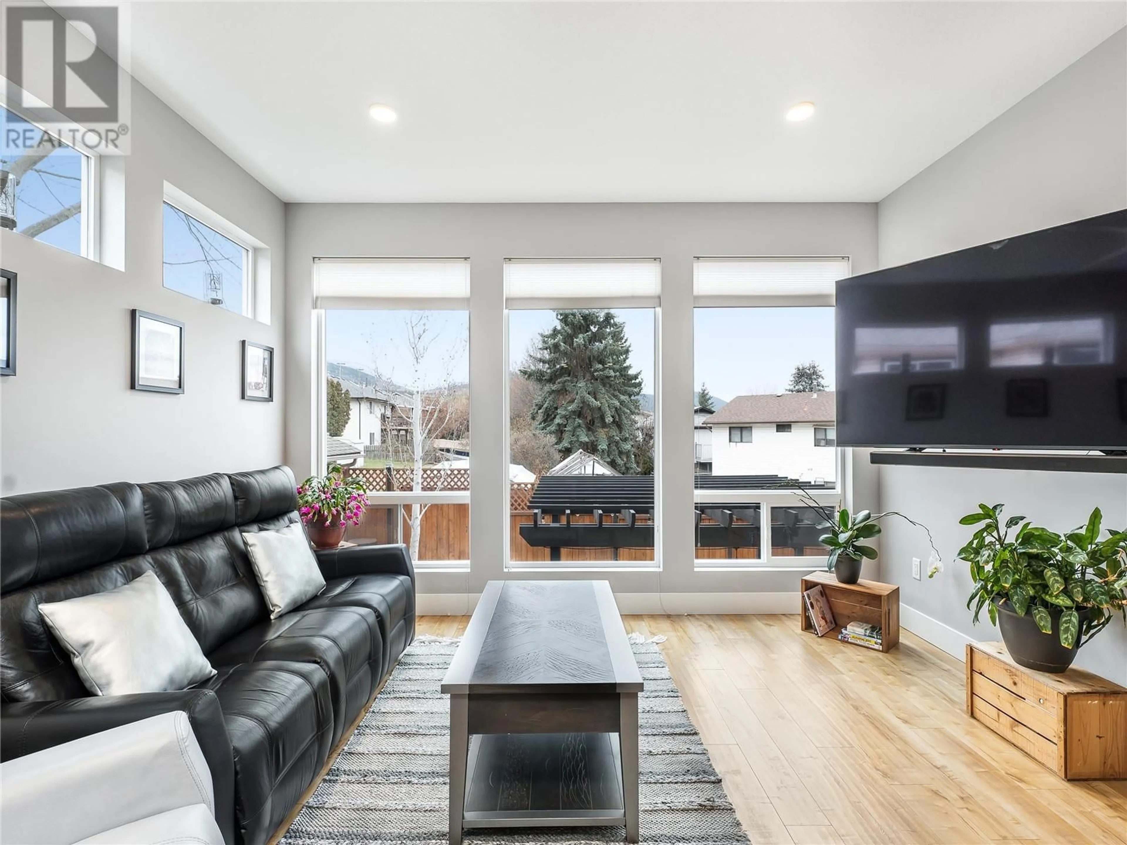 Living room with furniture, wood/laminate floor for 4204 14 Avenue, Vernon British Columbia V1H1J2