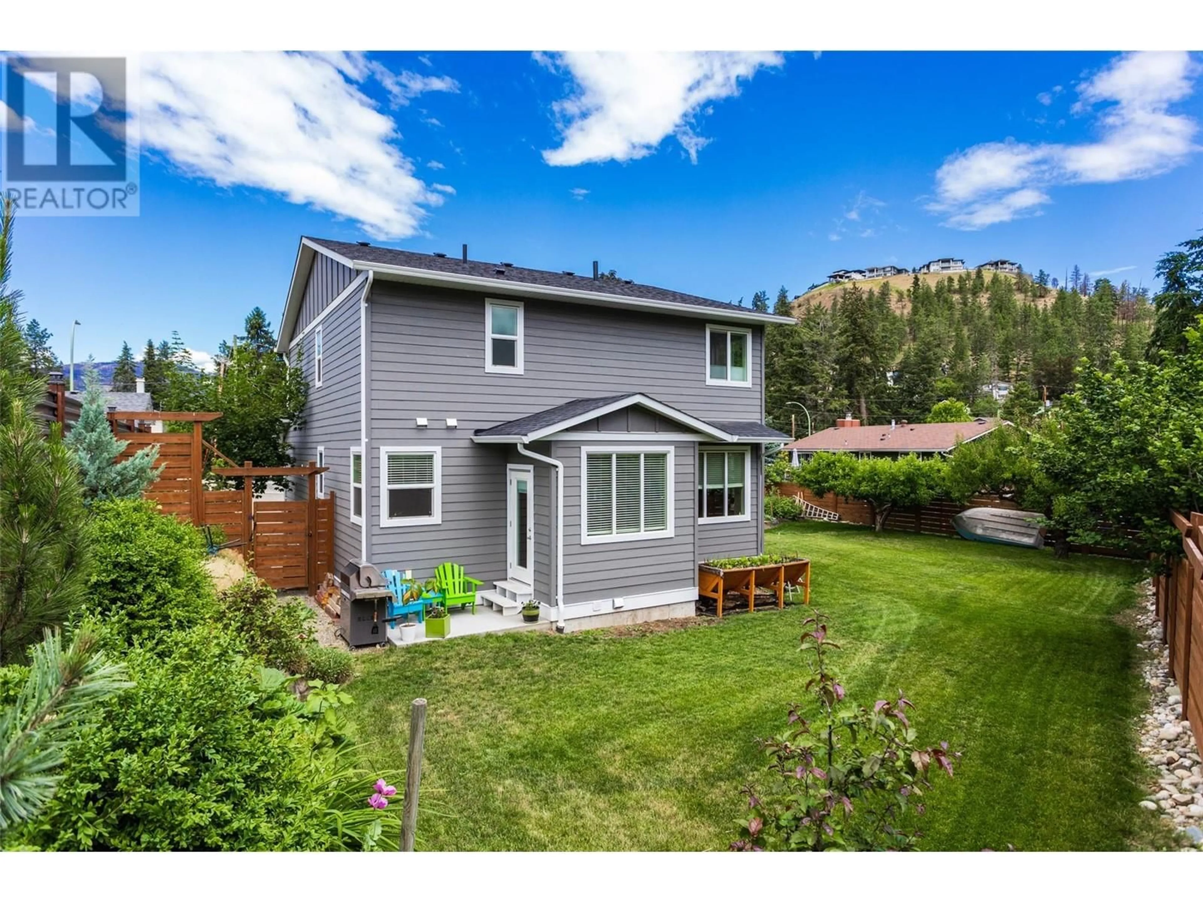 A pic from outside/outdoor area/front of a property/back of a property/a pic from drone, mountain view for 1259 Rio Drive, Kelowna British Columbia V1V1E2