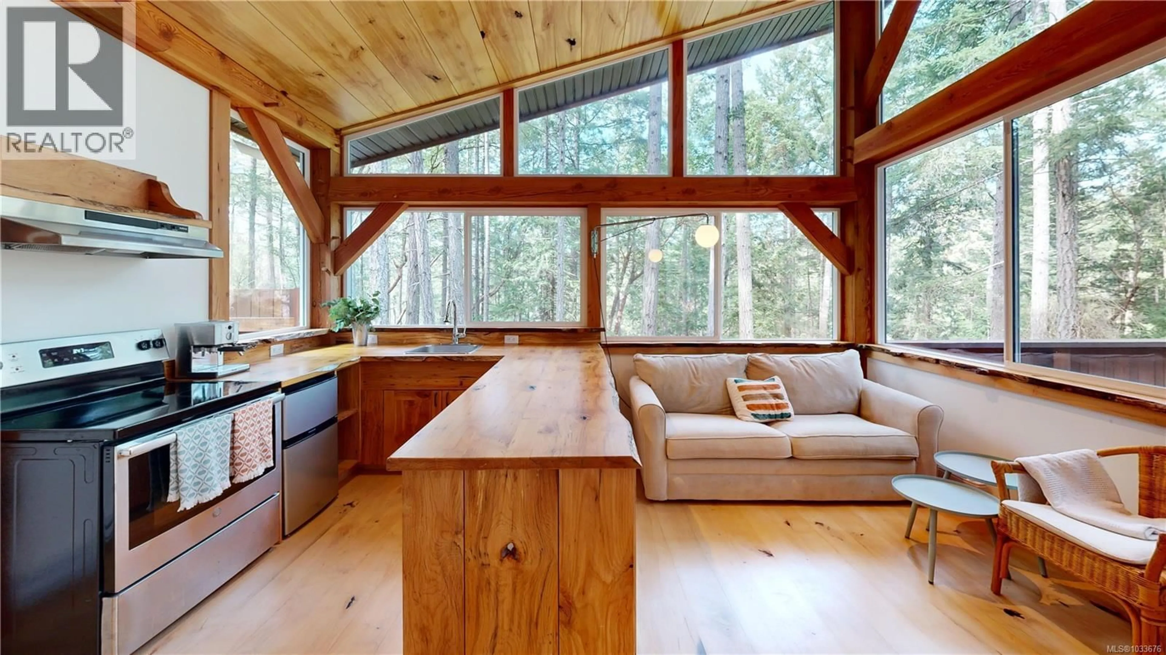 Open concept kitchen, wood/laminate floor for 153 SOCKEYE DRIVE, Mudge Island British Columbia V0R1X0